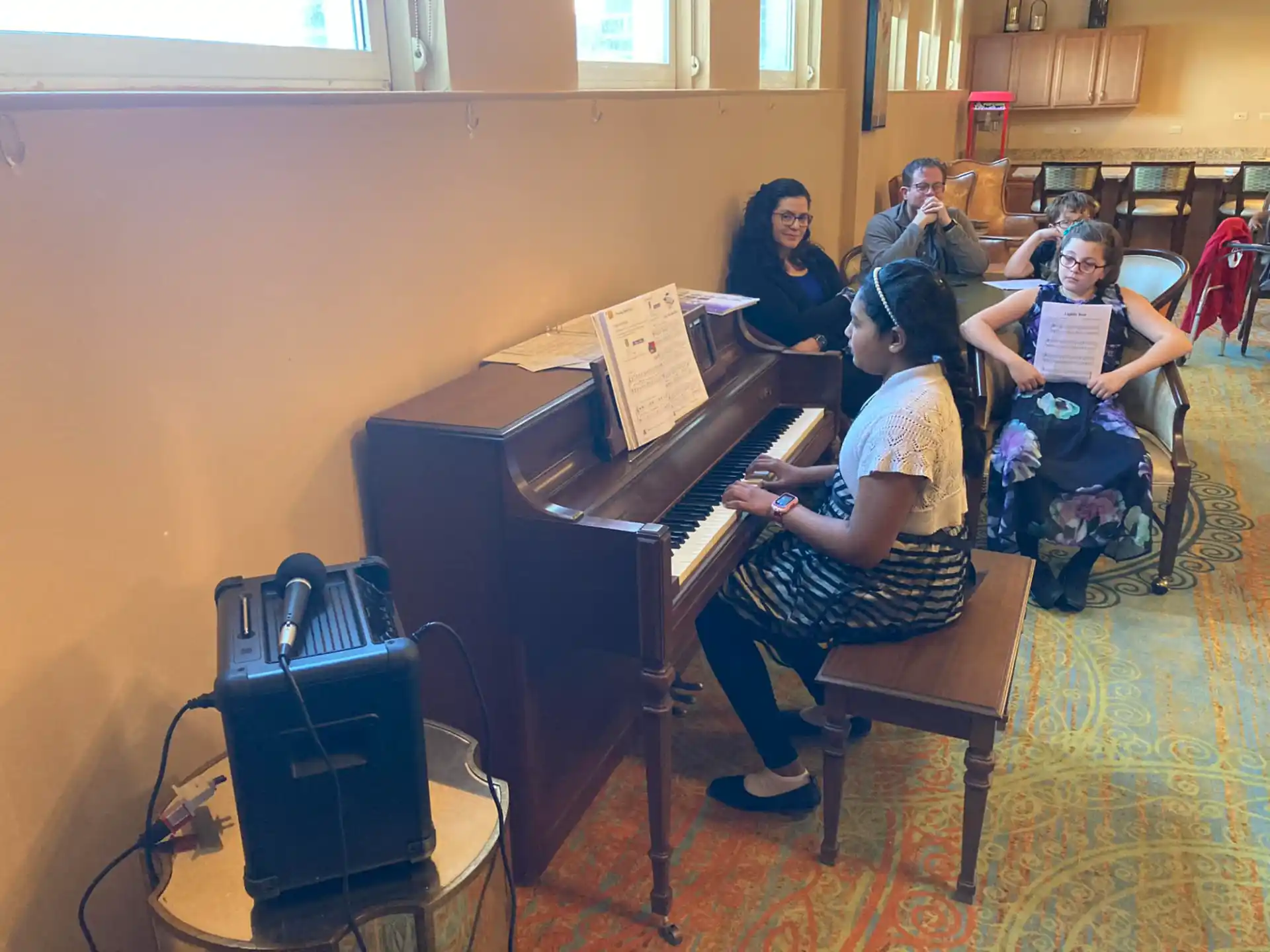 a group of people playing piano