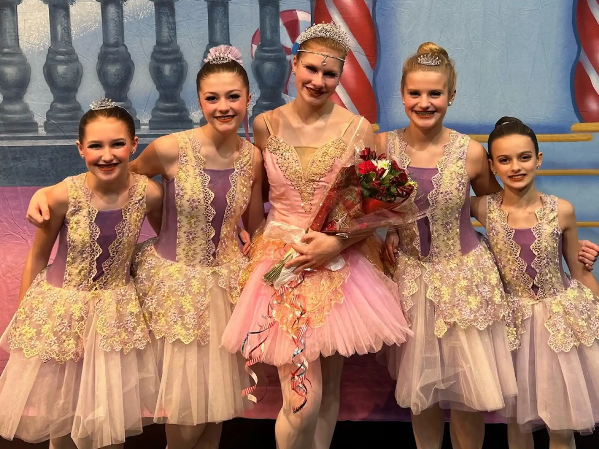 a group of people wearing dresses and posing for the camera