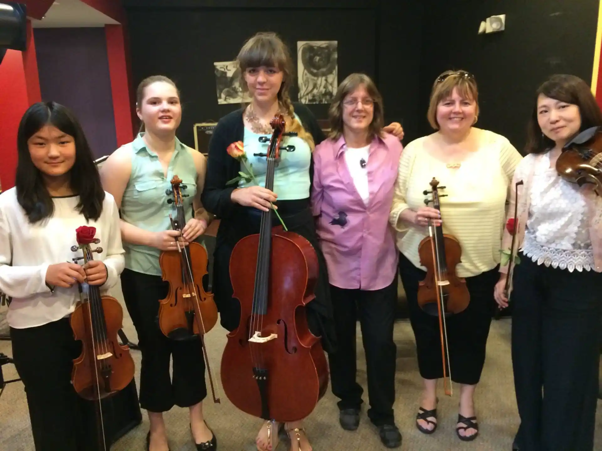 a group of women holding musical instruments