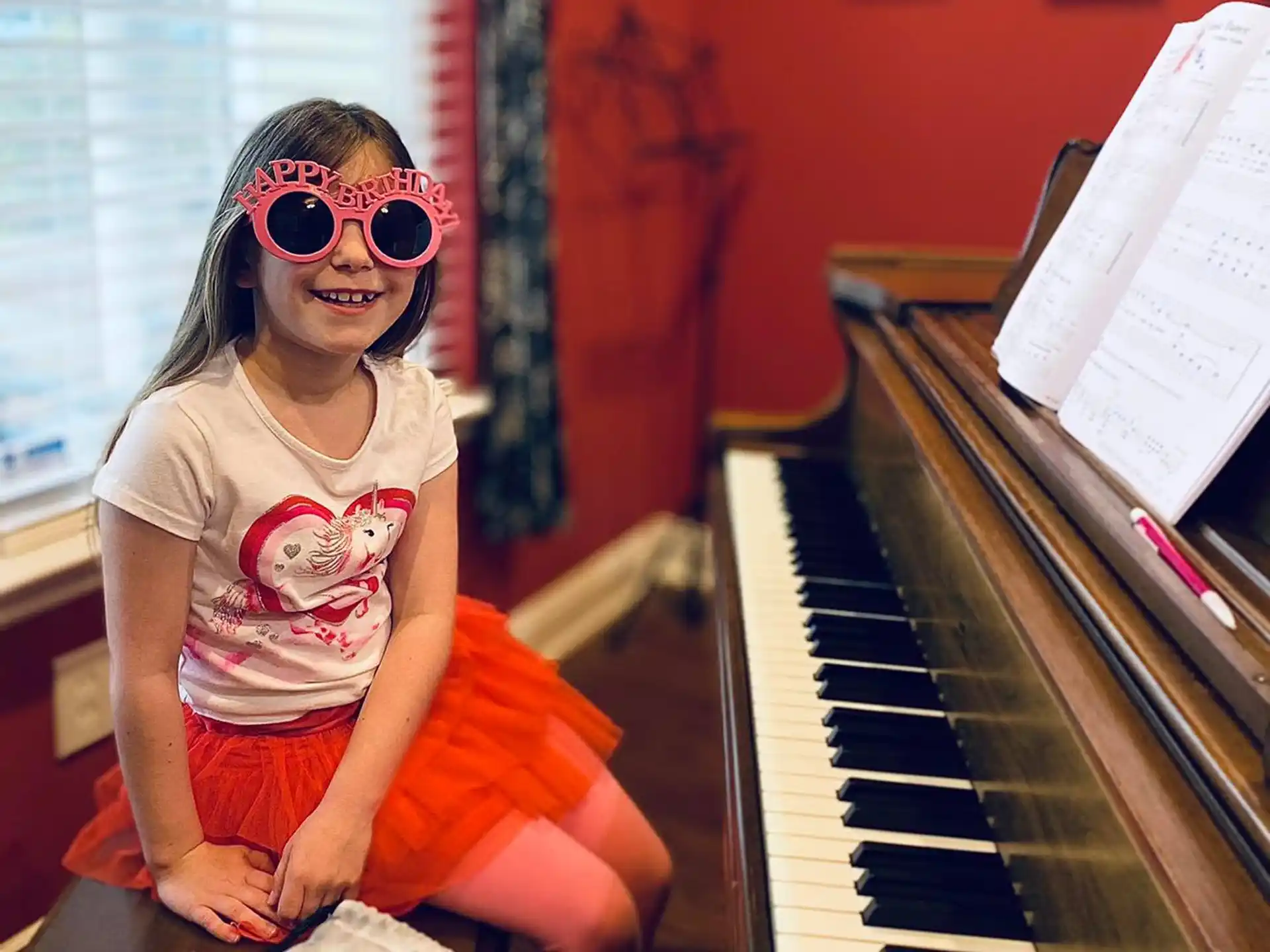 a person sitting on a piano