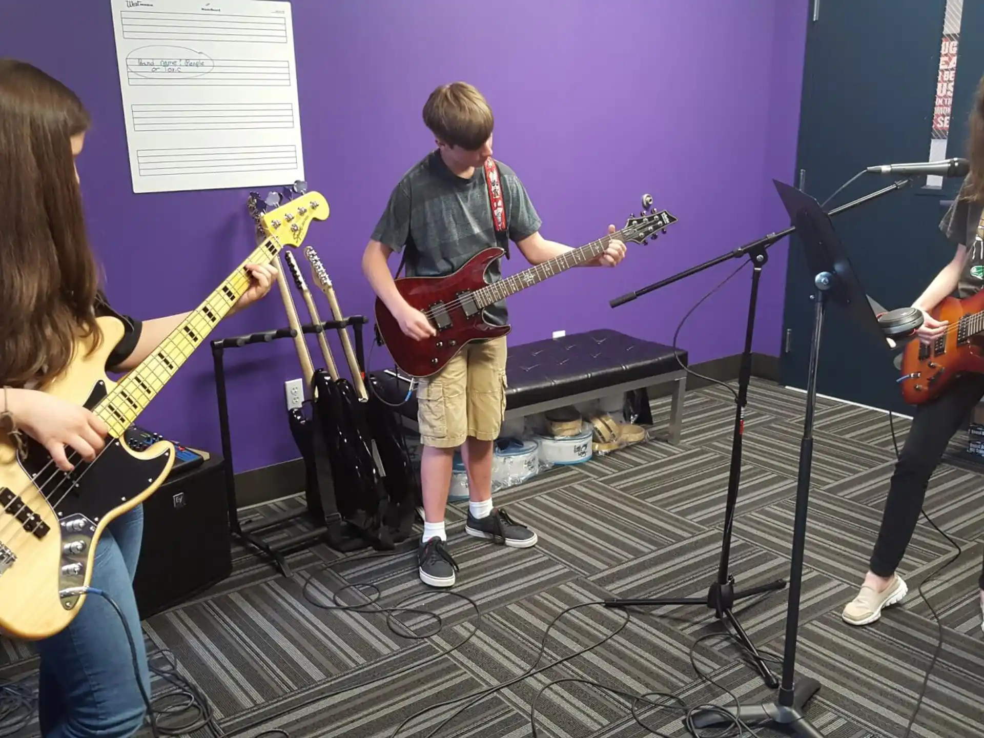 a group of people playing guitars