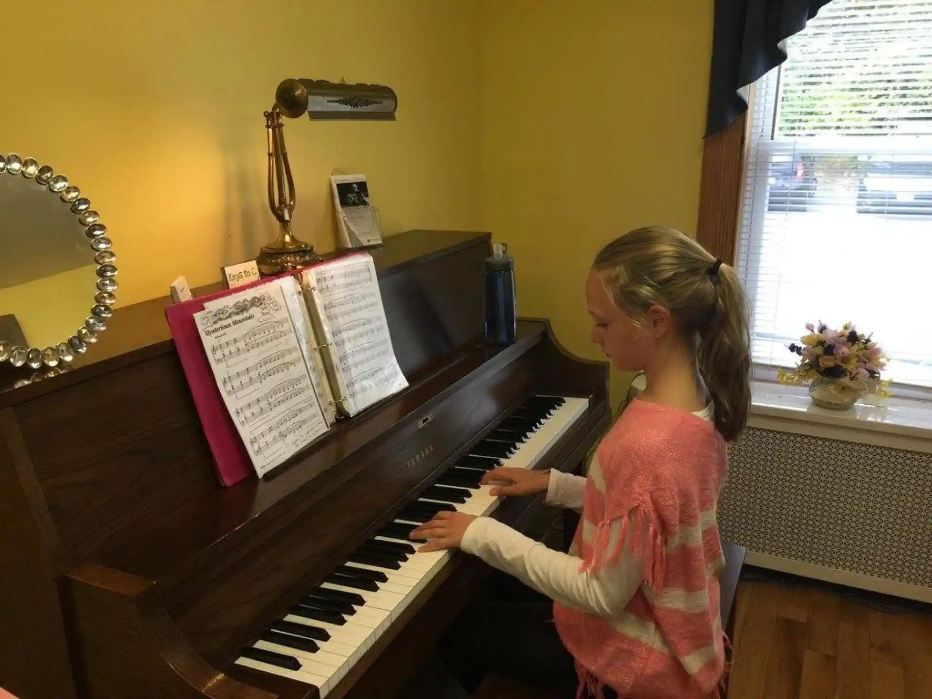 a girl playing a piano