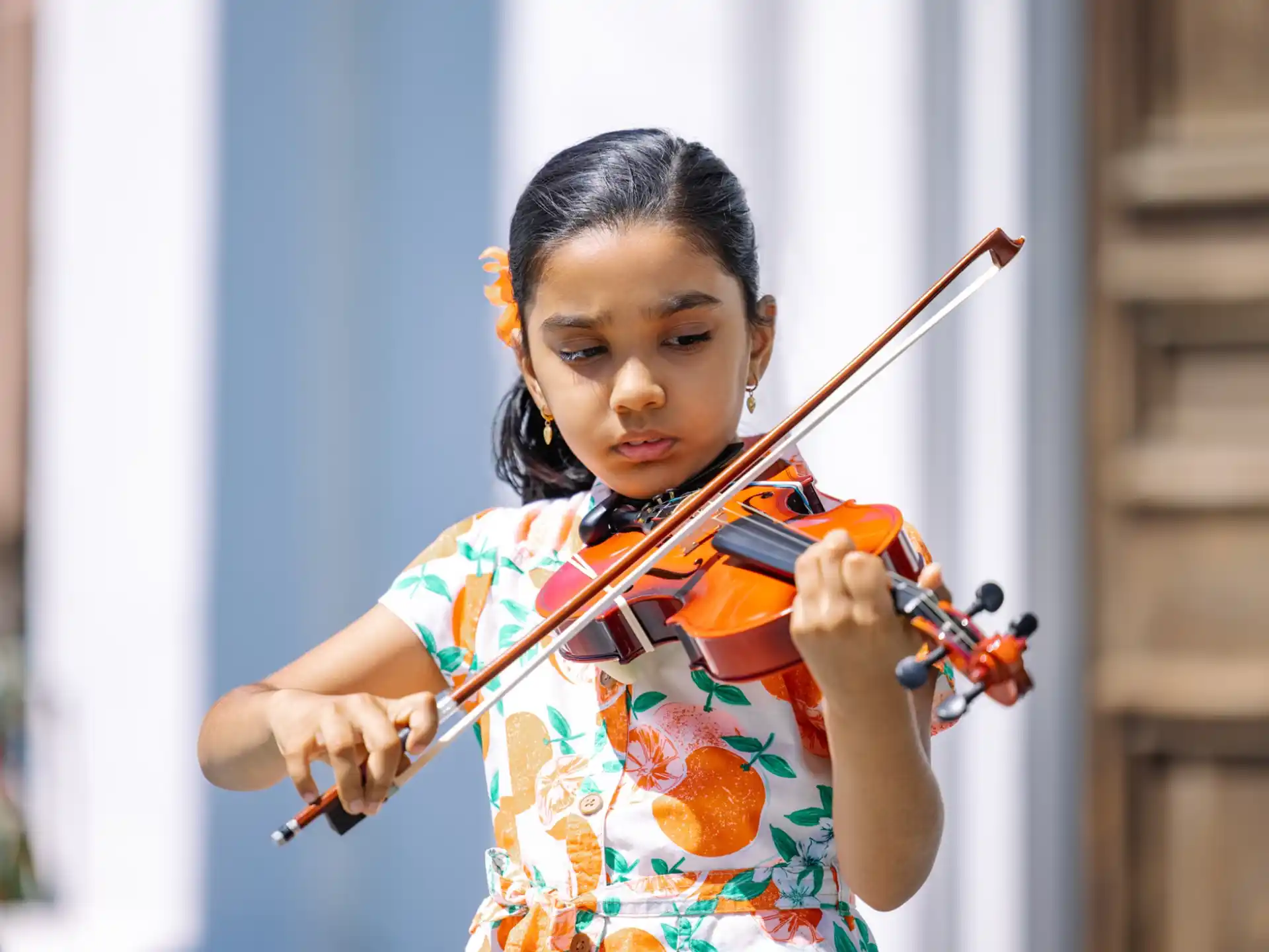 a young girl playing violin
