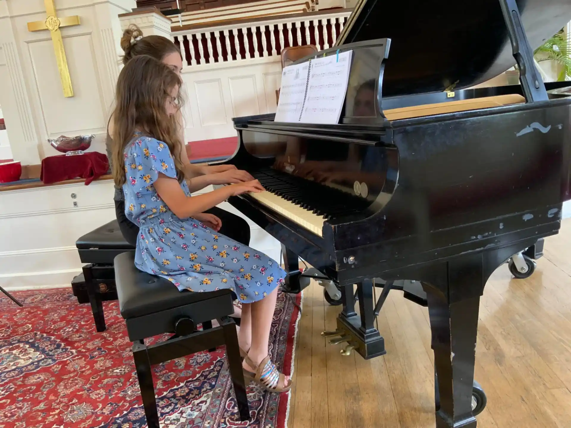 a girl playing a piano