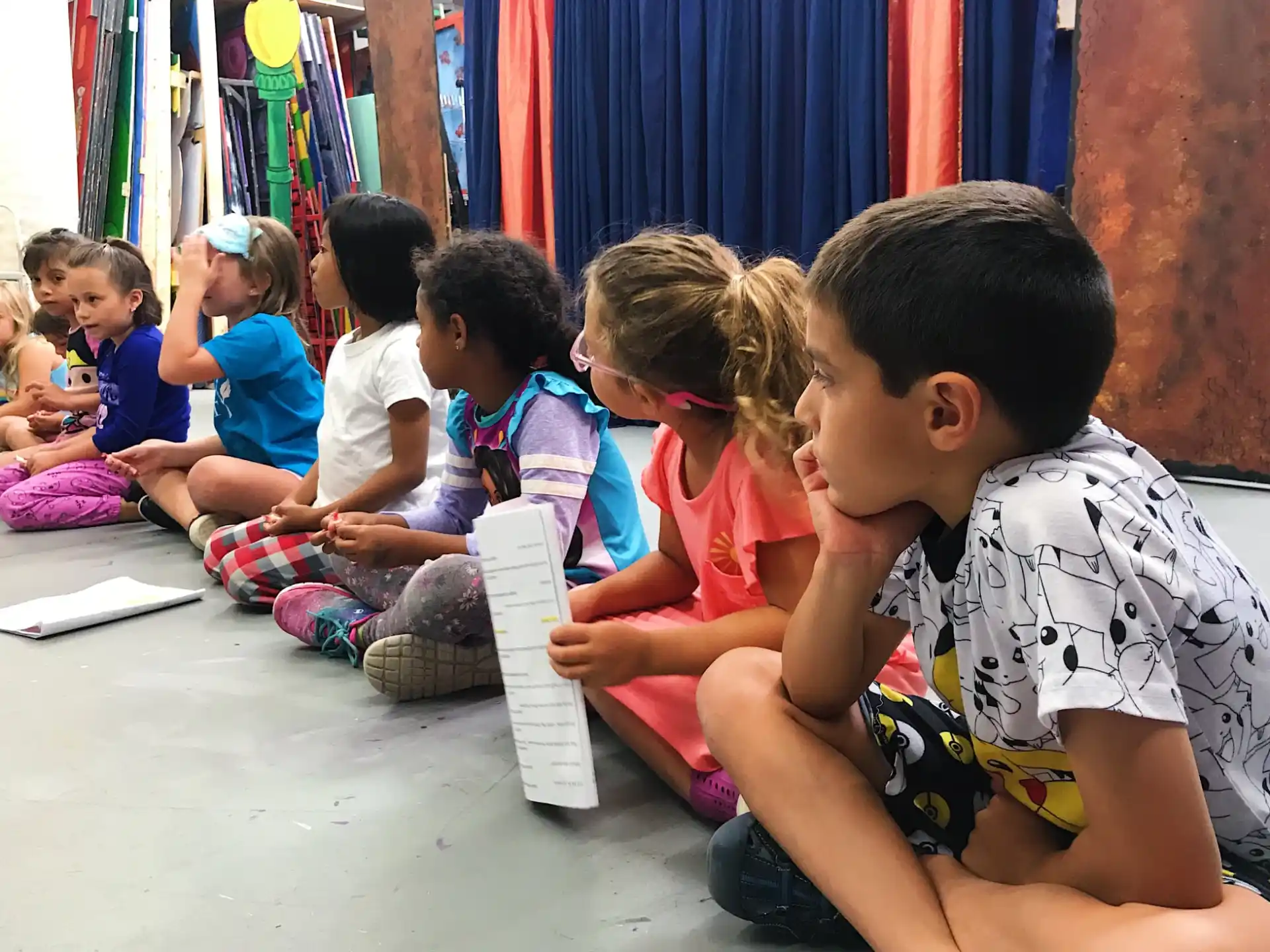 a group of children sitting on the floor