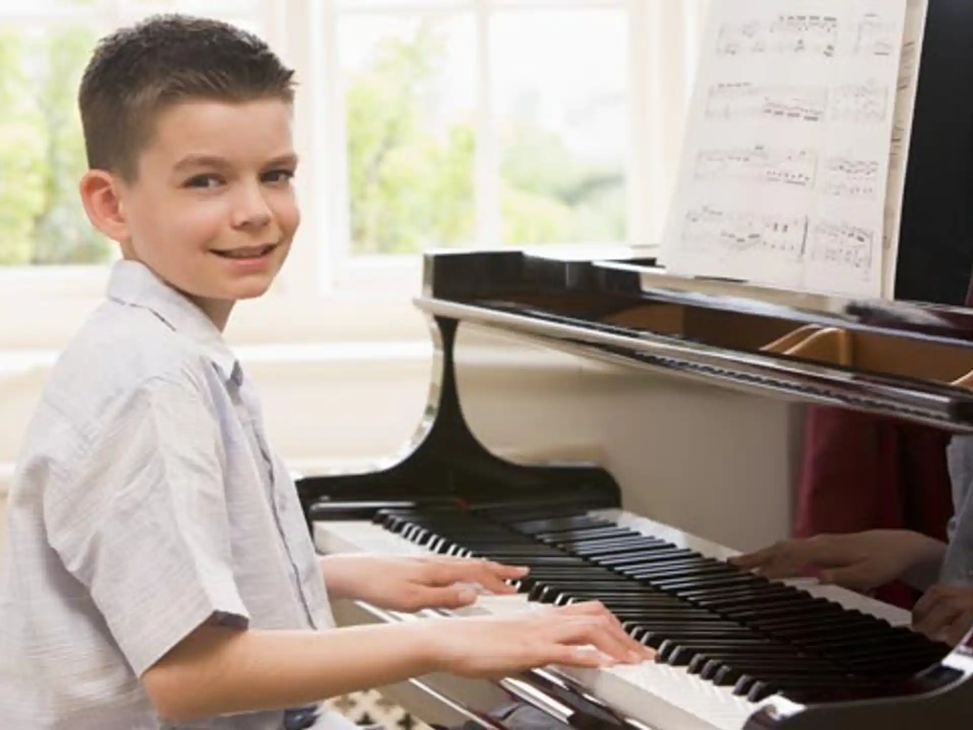 a boy playing a piano
