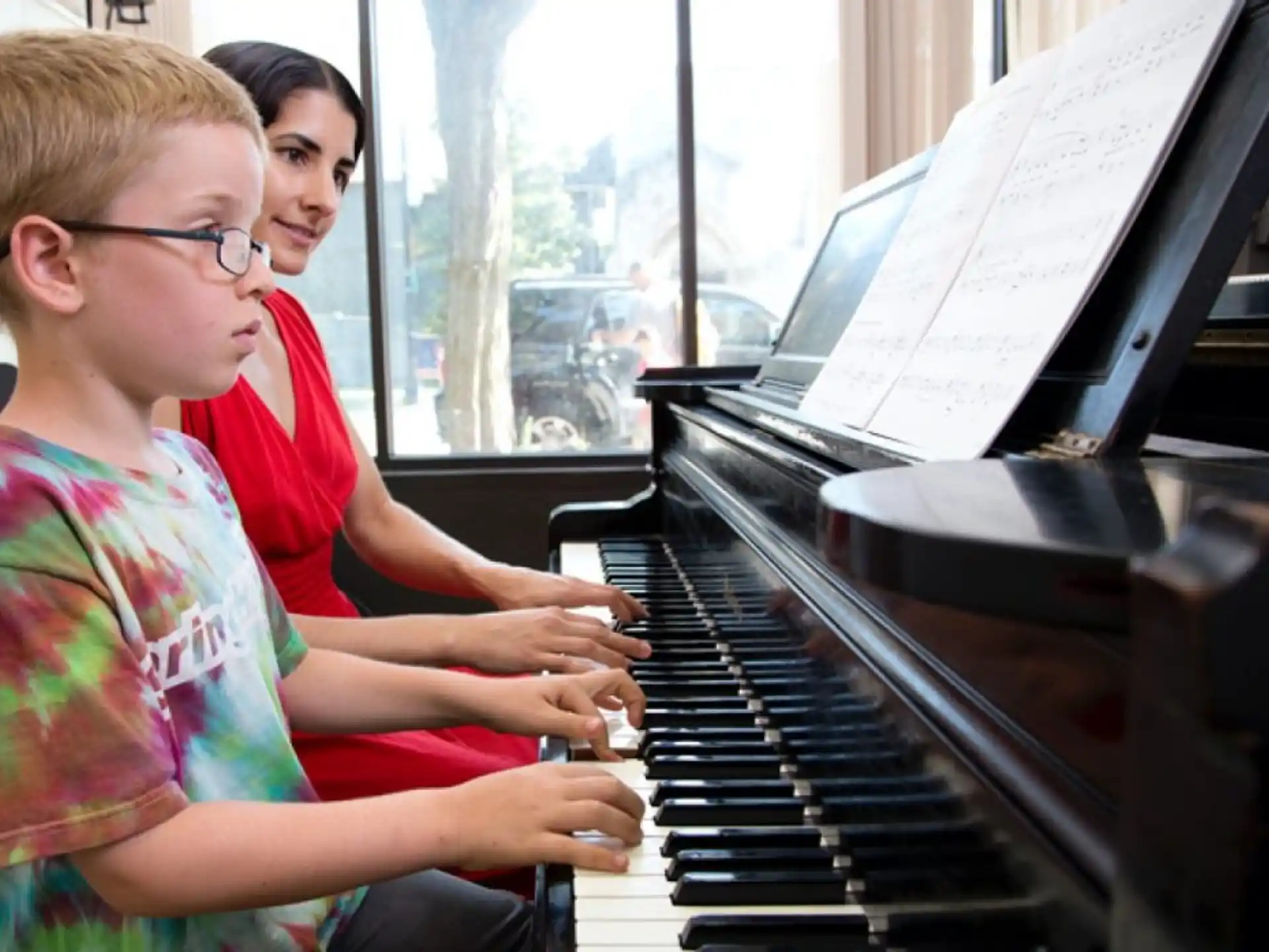 a couple of kids playing piano