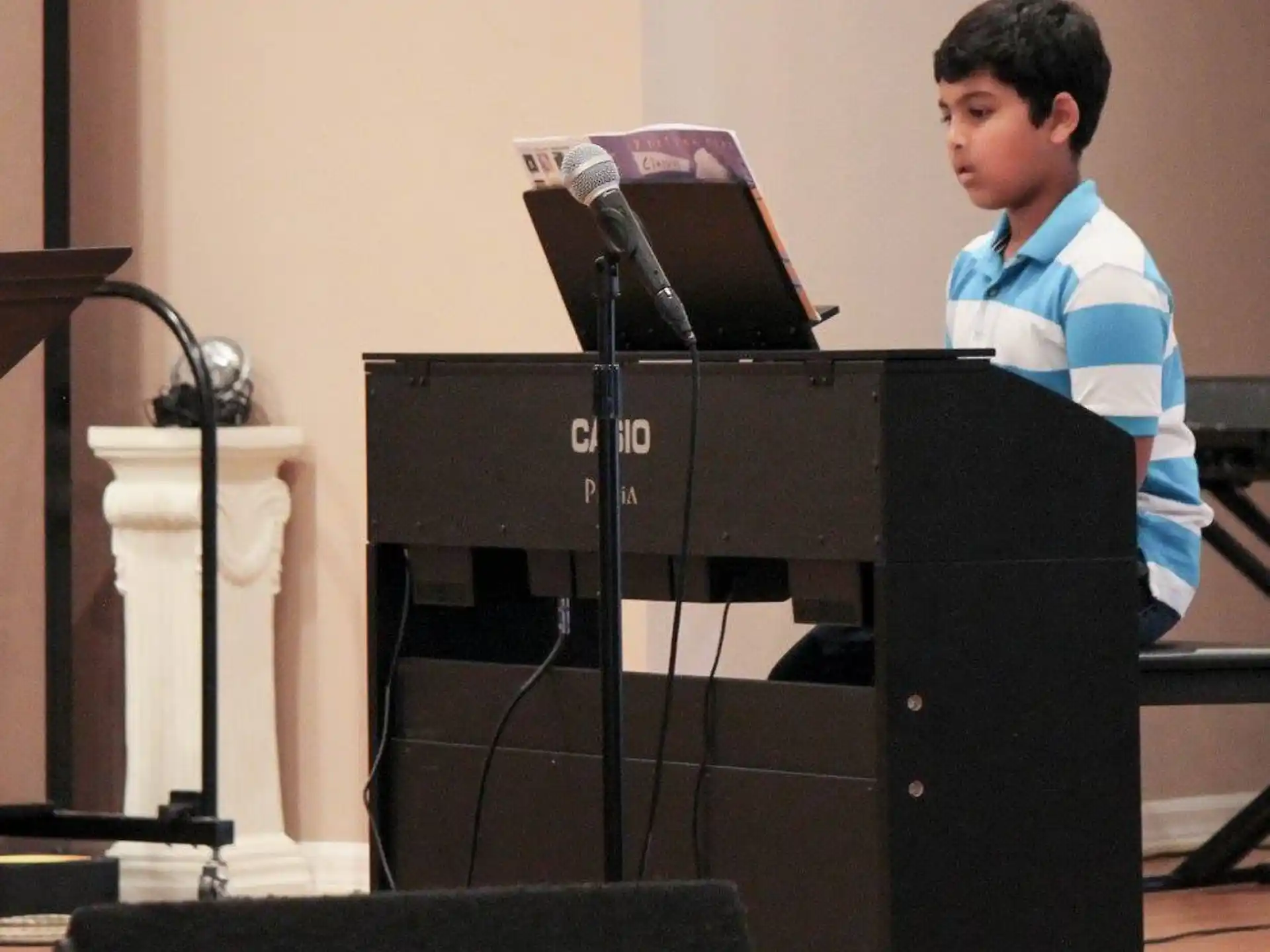 a boy standing behind a podium