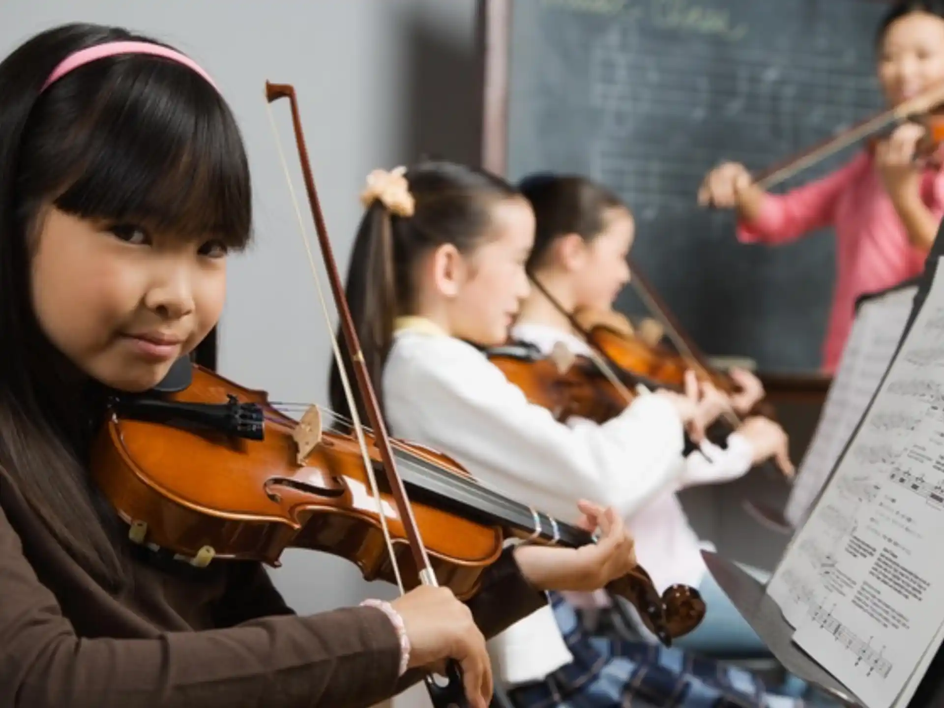 a group of kids playing violin