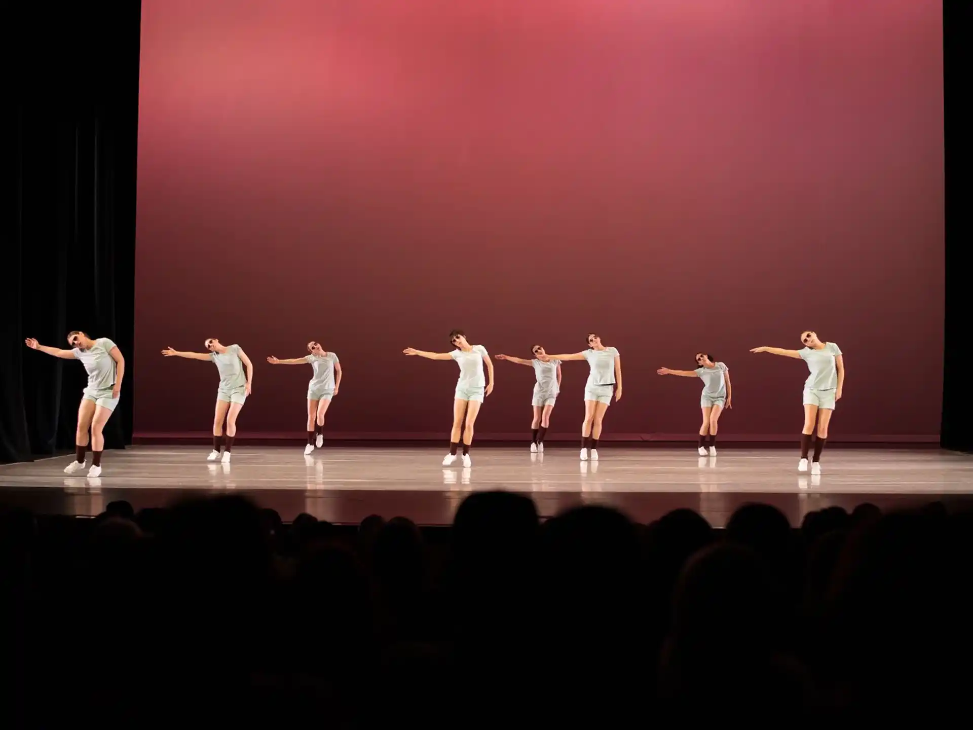 a group of people dancing on a stage