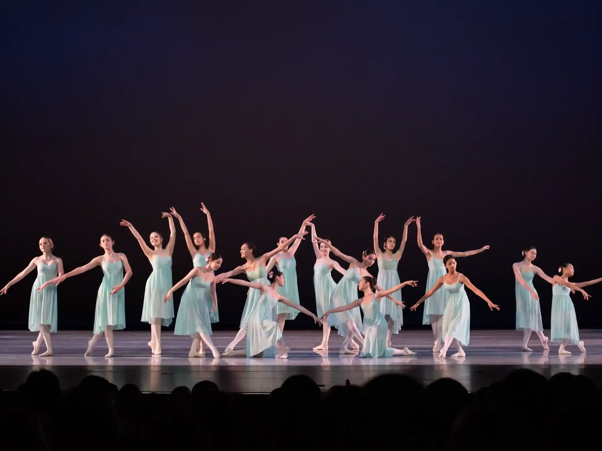 a group of people dancing on a stage