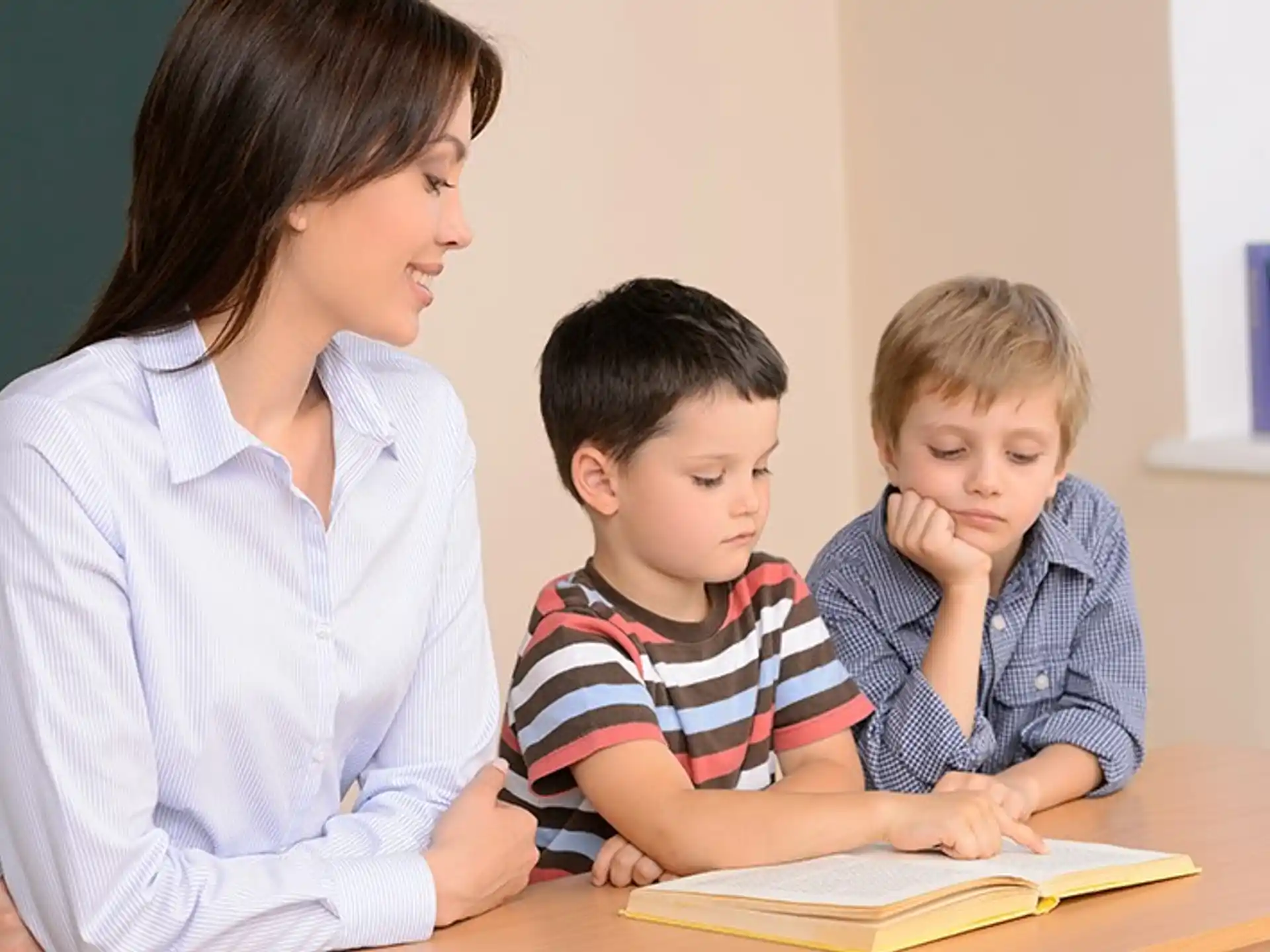 a person and a child looking at a book