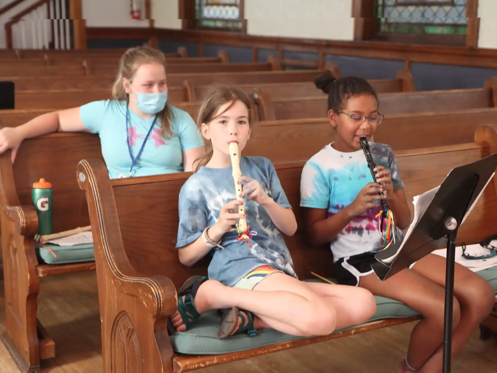 a group of kids sitting in chairs with musical instruments