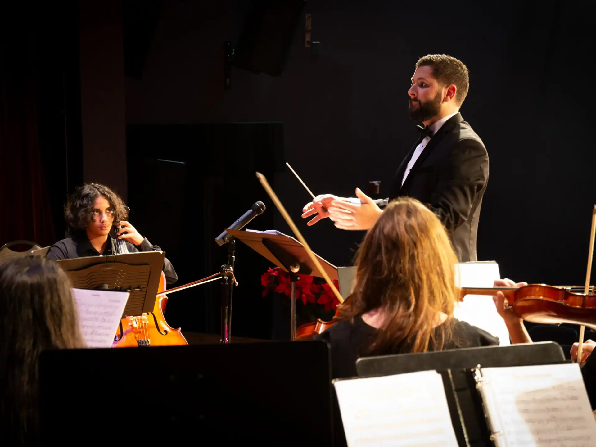 a man standing in front of an orchestra
