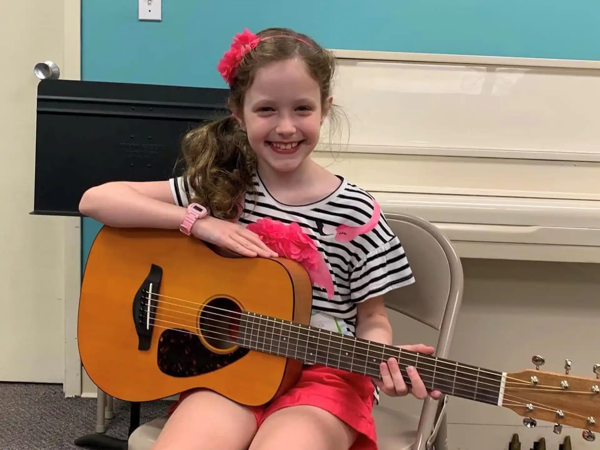 a girl playing a guitar