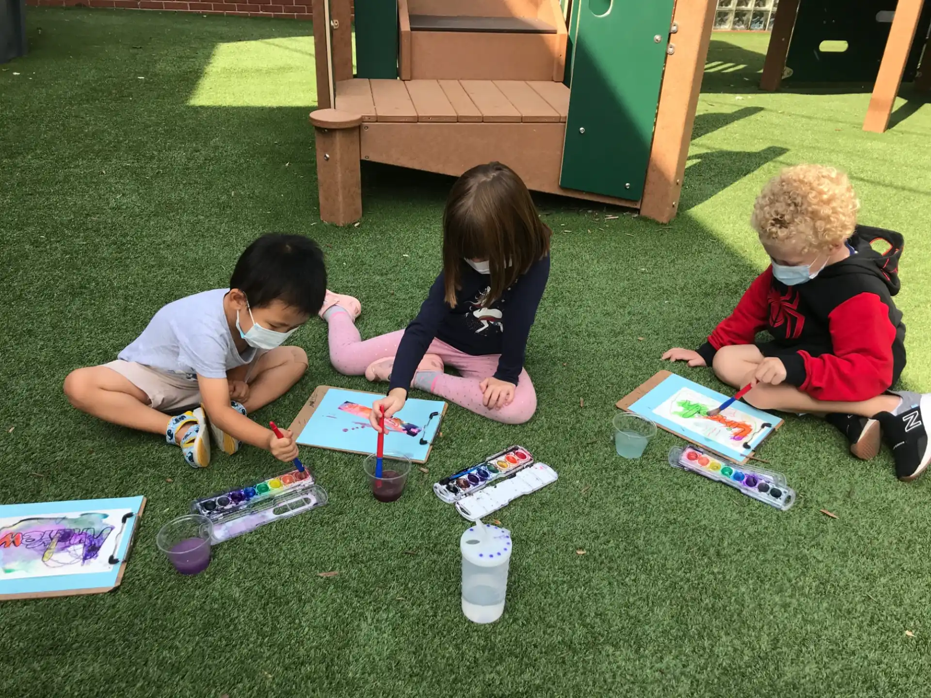children sitting on the grass