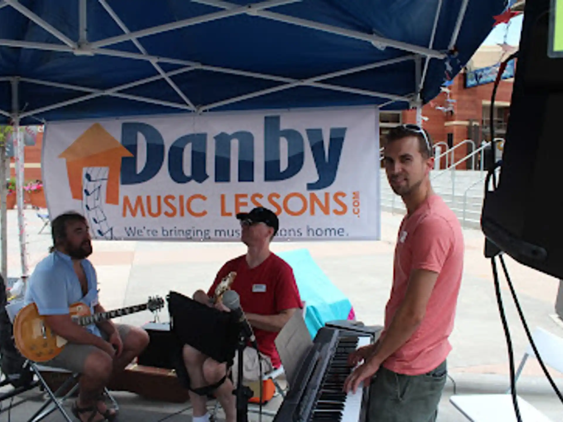 a group of men playing instruments under a tent
