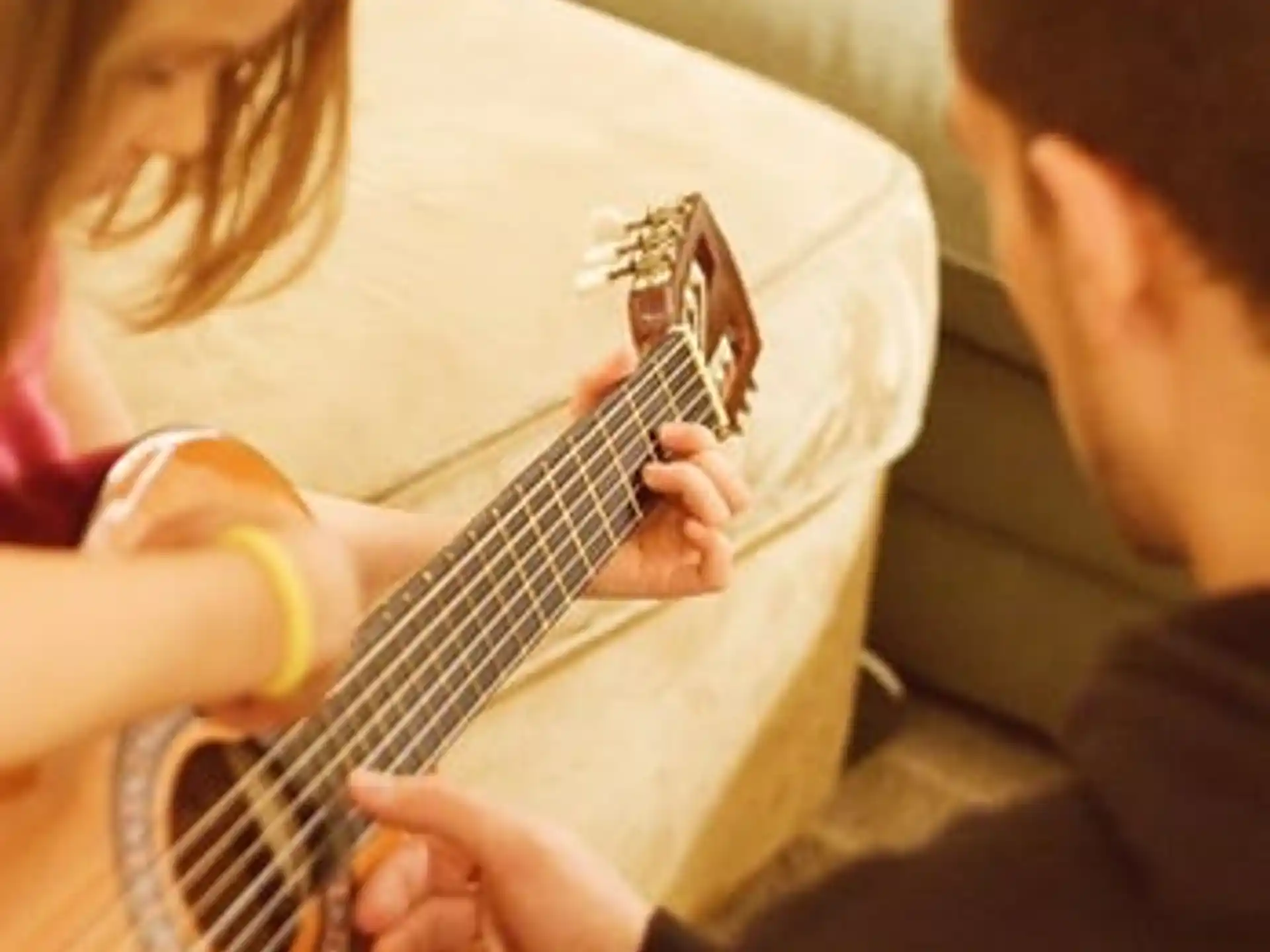 a woman playing a guitar