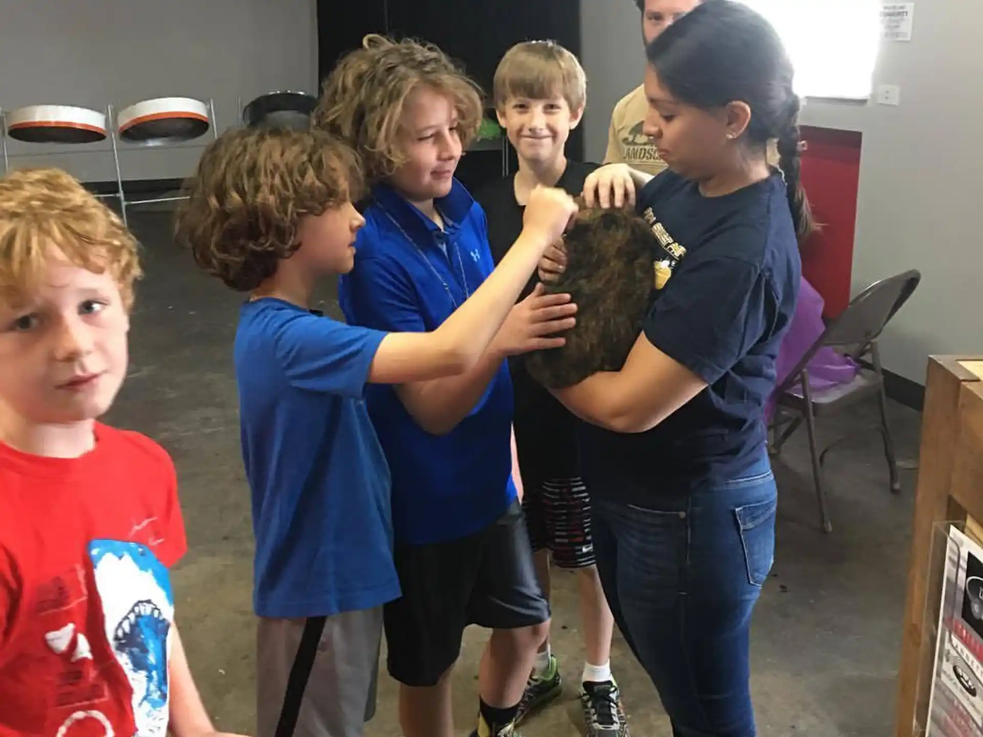 a group of kids holding a ball