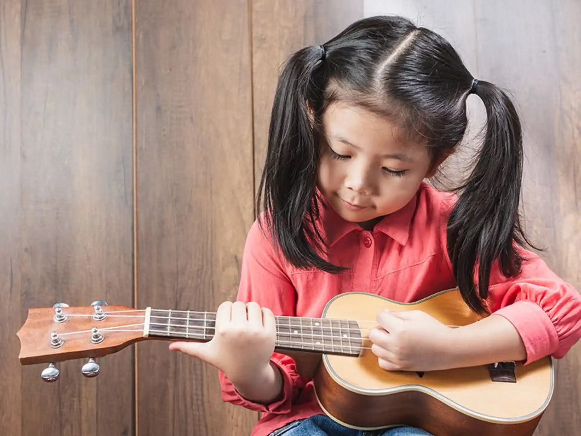 a girl playing a guitar