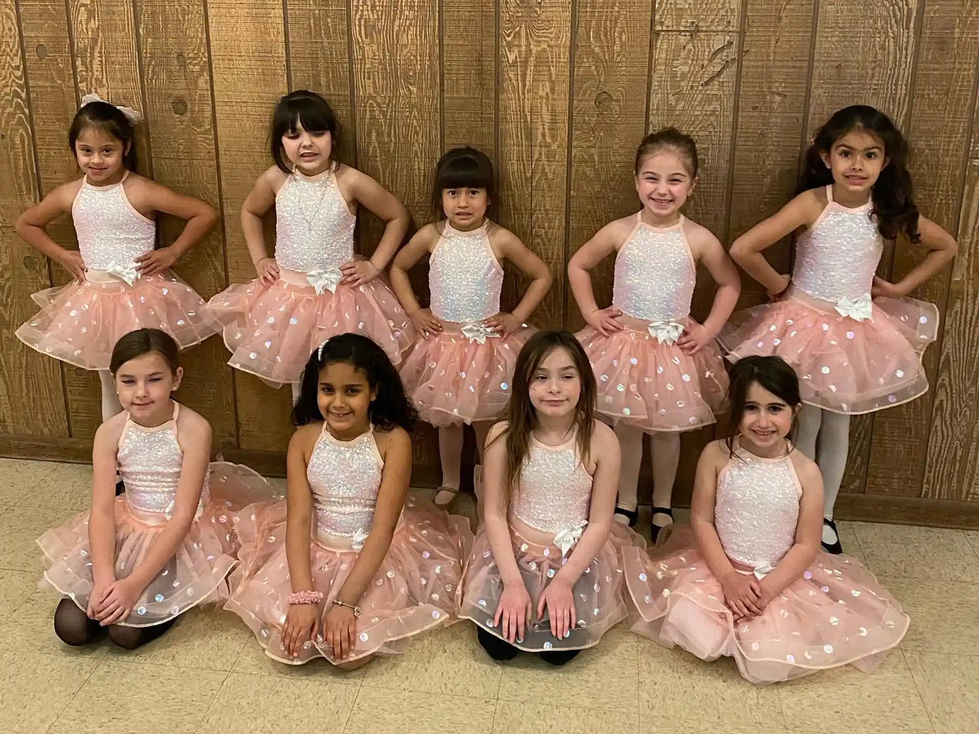 a group of girls in dresses