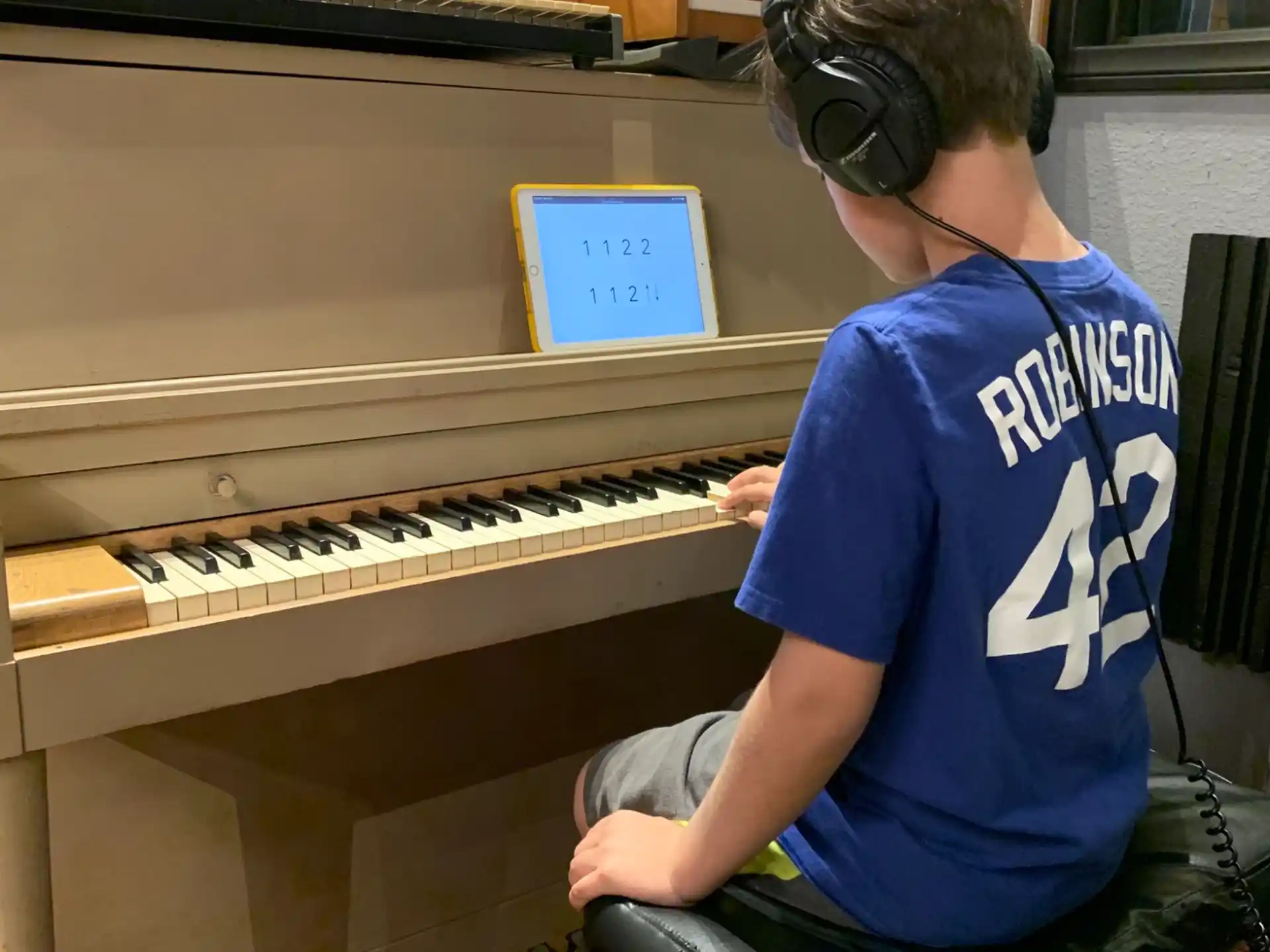 a boy playing a piano