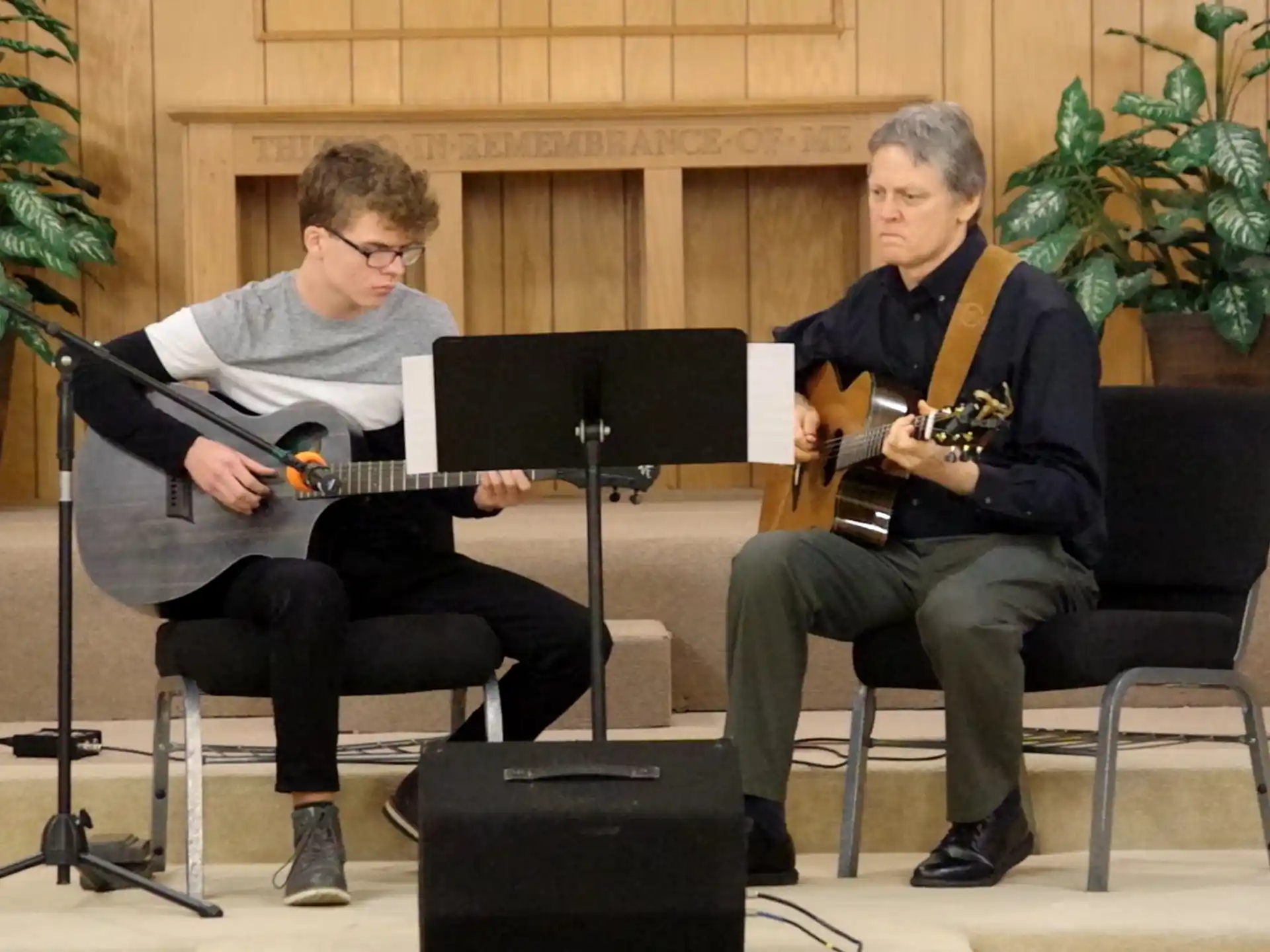 two men playing guitars