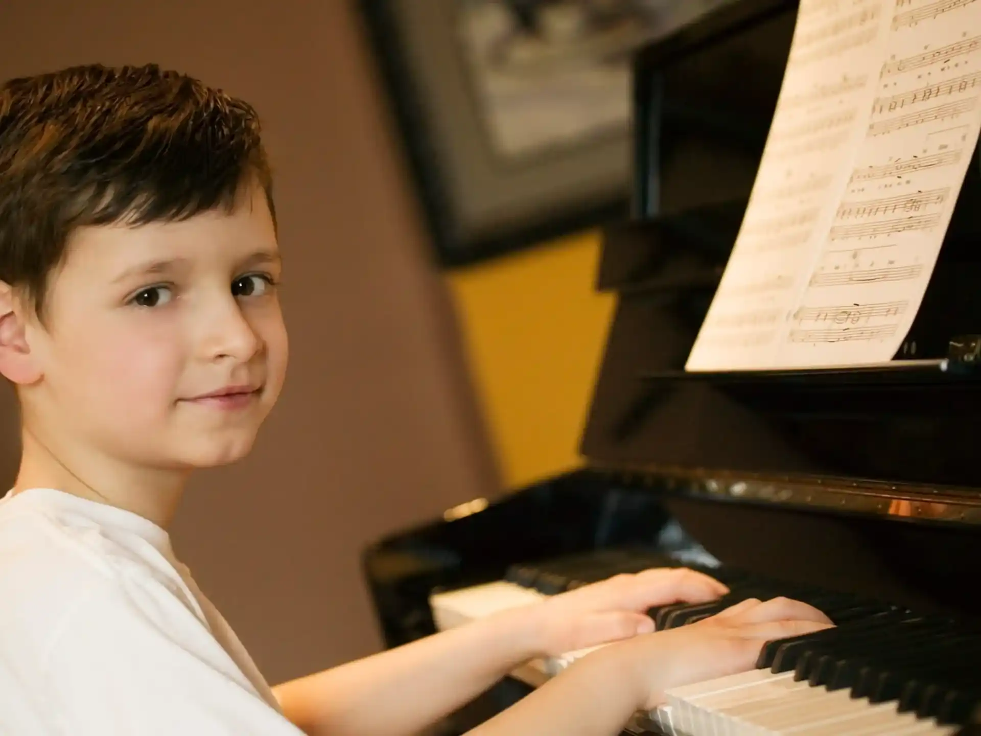 a boy playing a piano