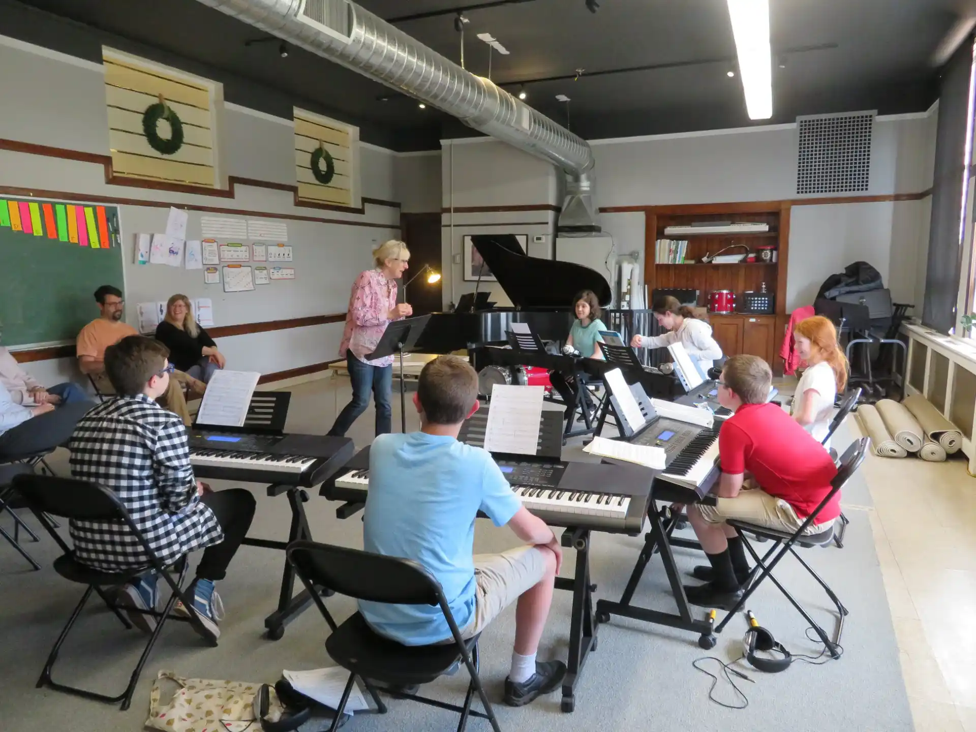 a group of people sitting at a table with musical instruments