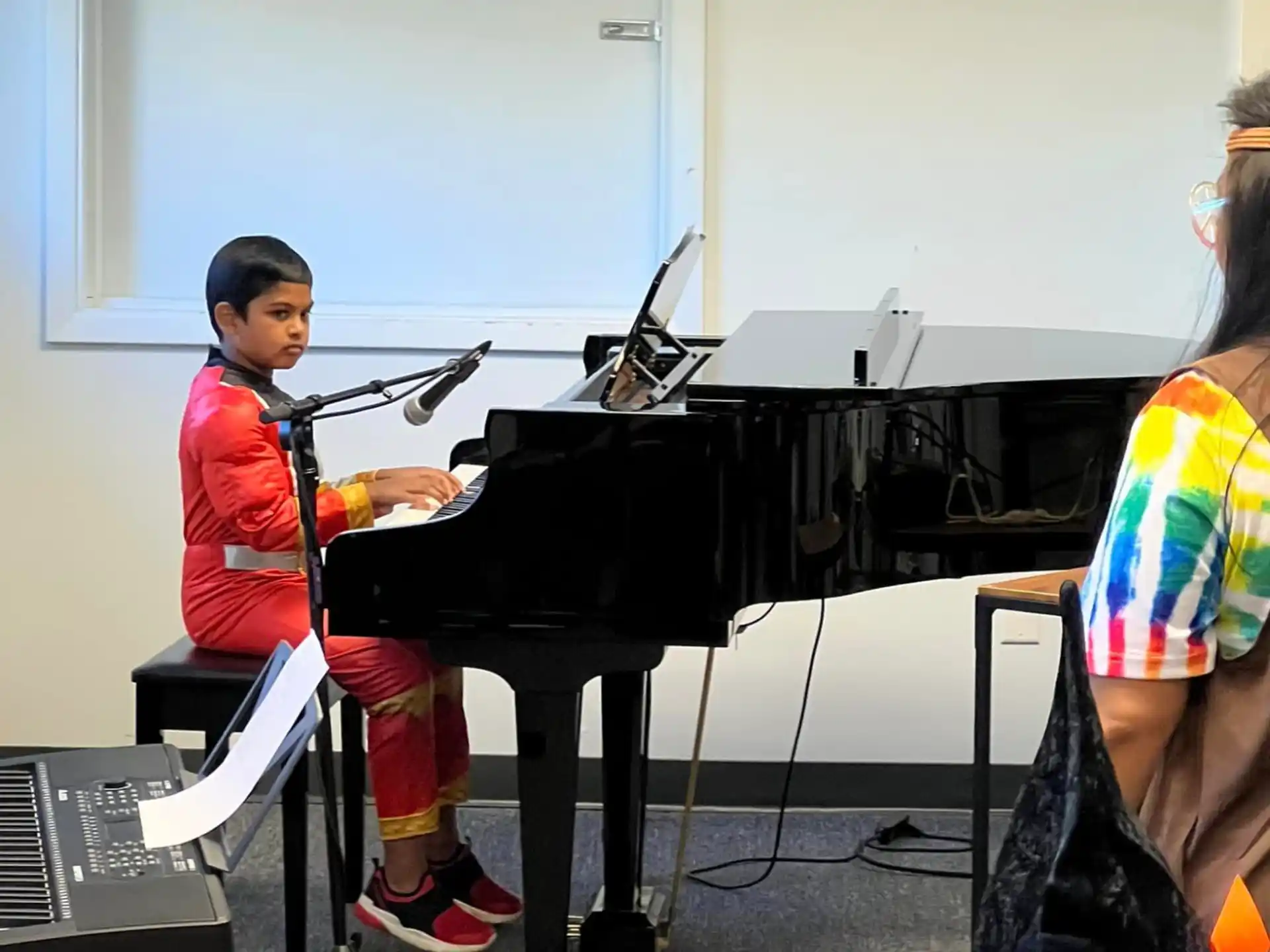 a boy playing a piano