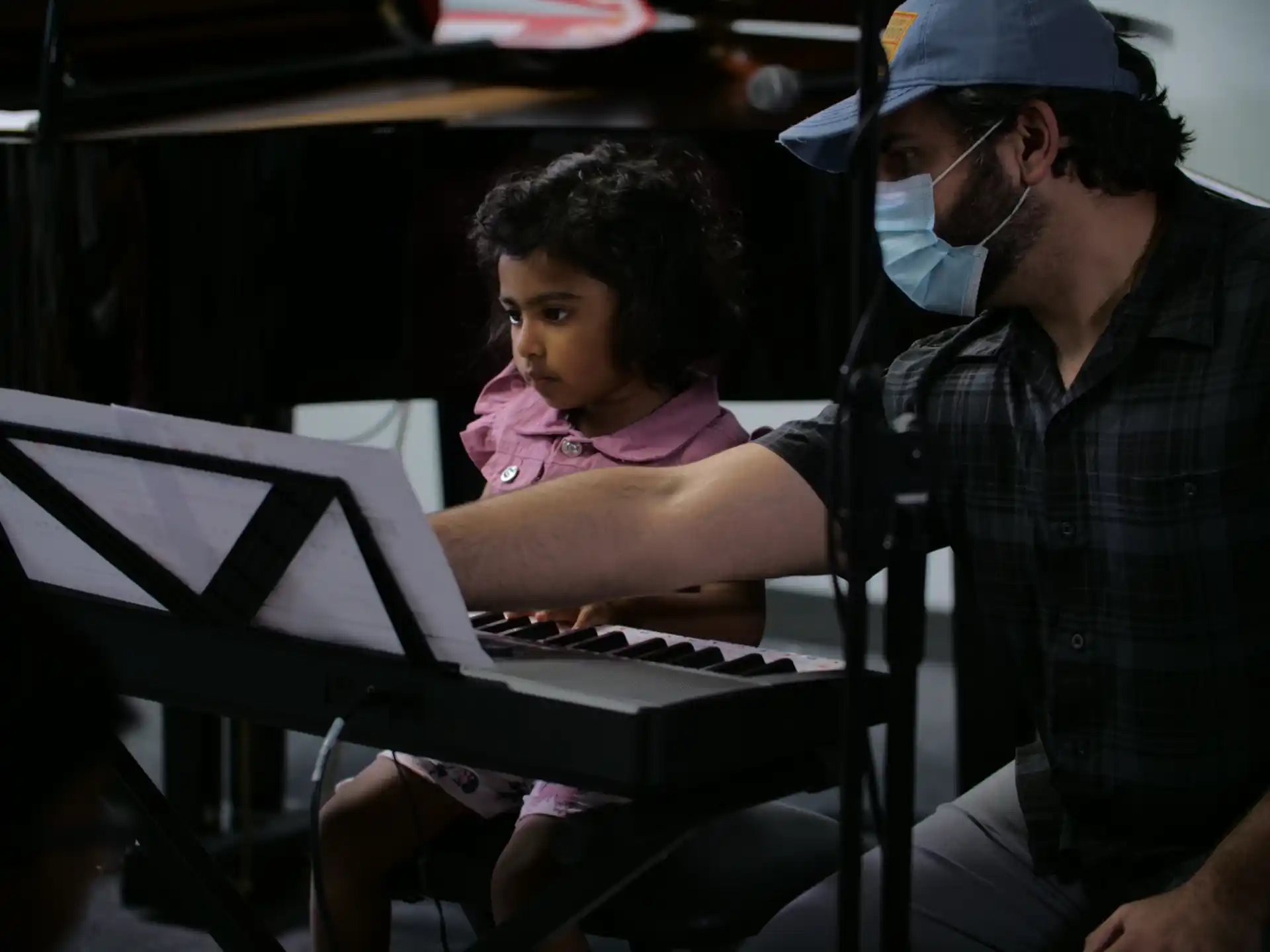 a man and a child playing piano