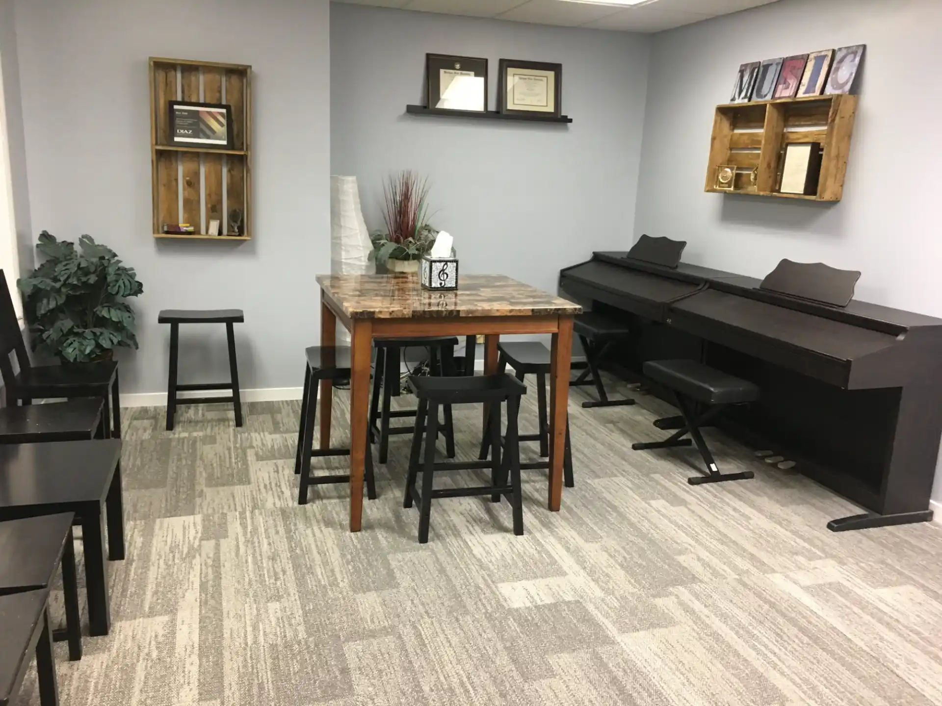 a room with a piano and chairs
