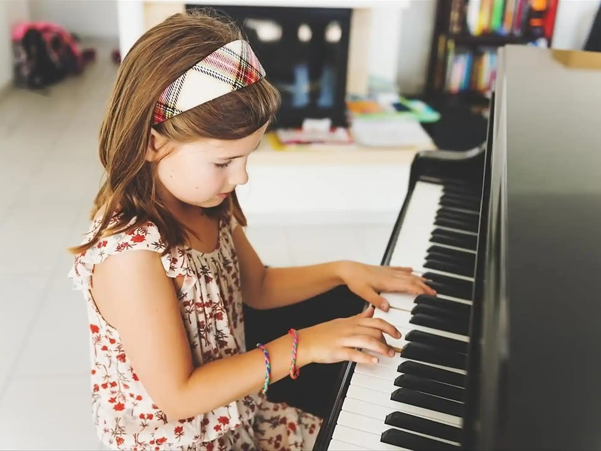 a girl playing a piano