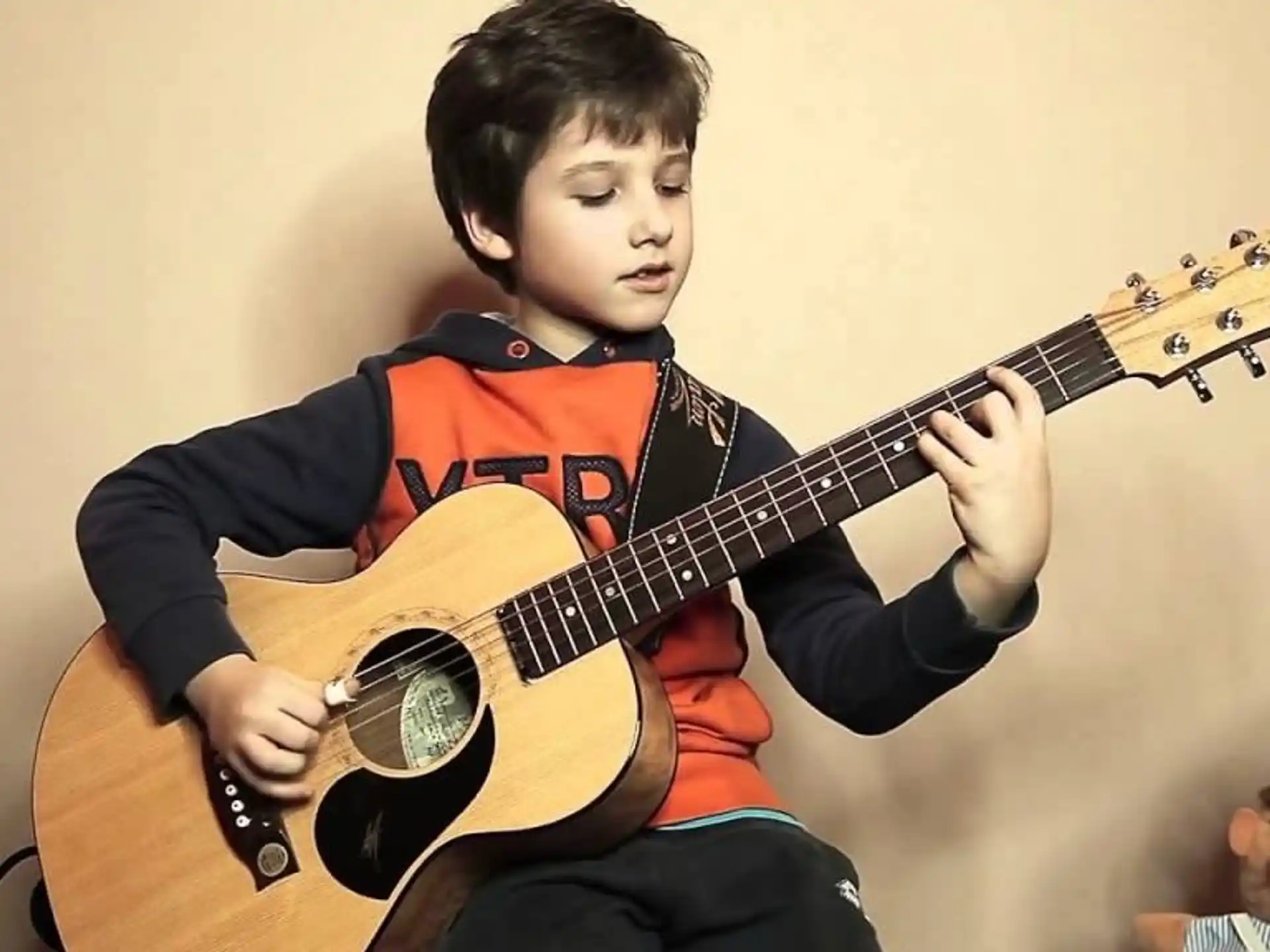a boy playing a guitar