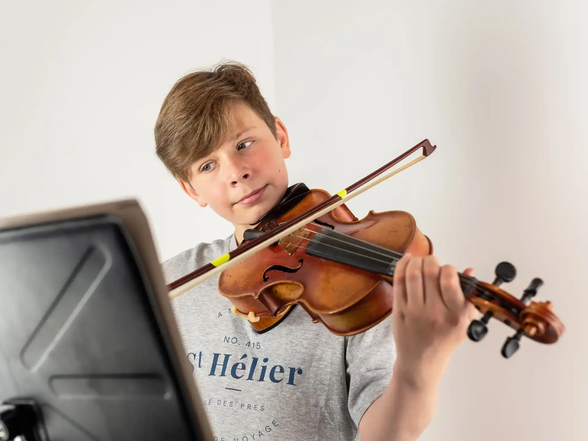 a boy playing a violin