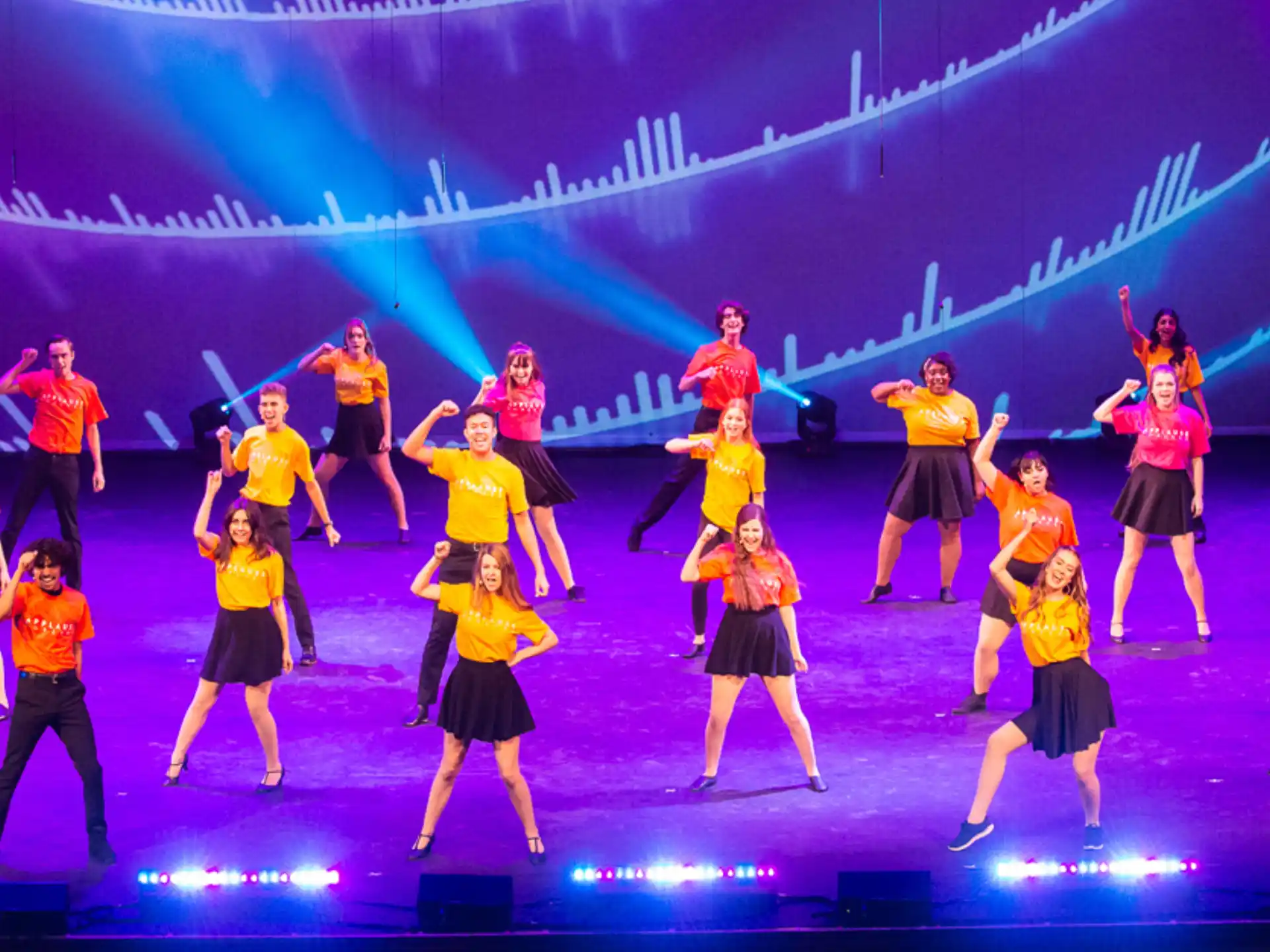 a group of people dancing on a stage