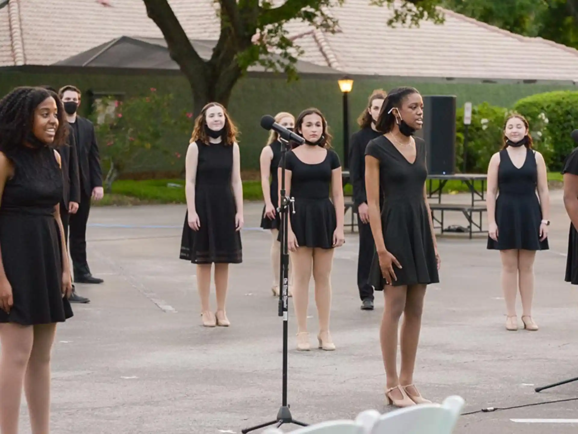a group of women in black dresses
