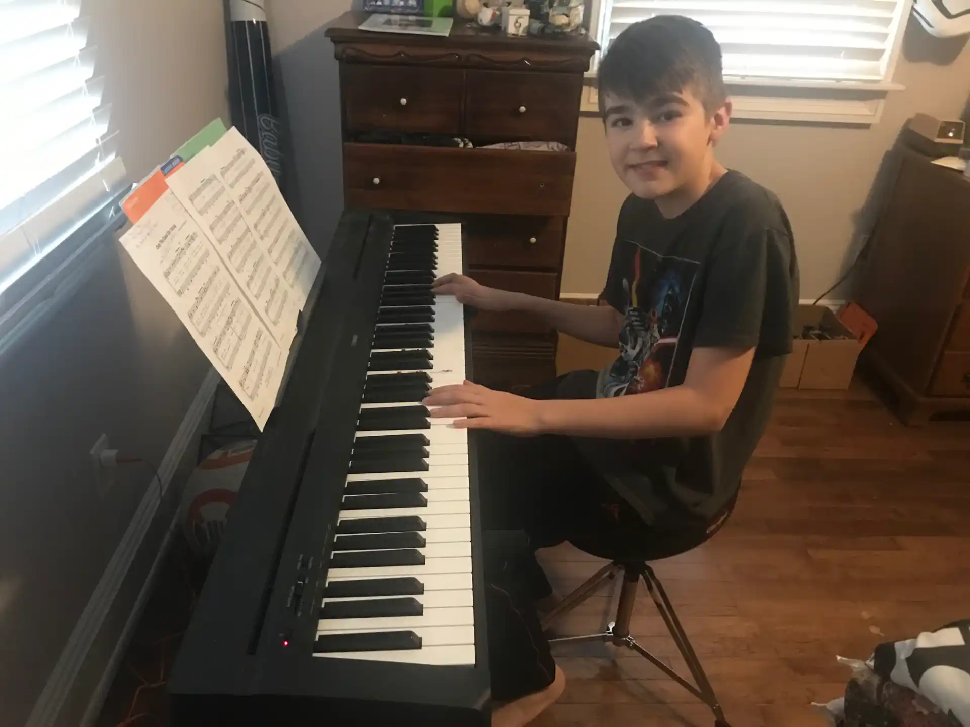 a boy playing a piano