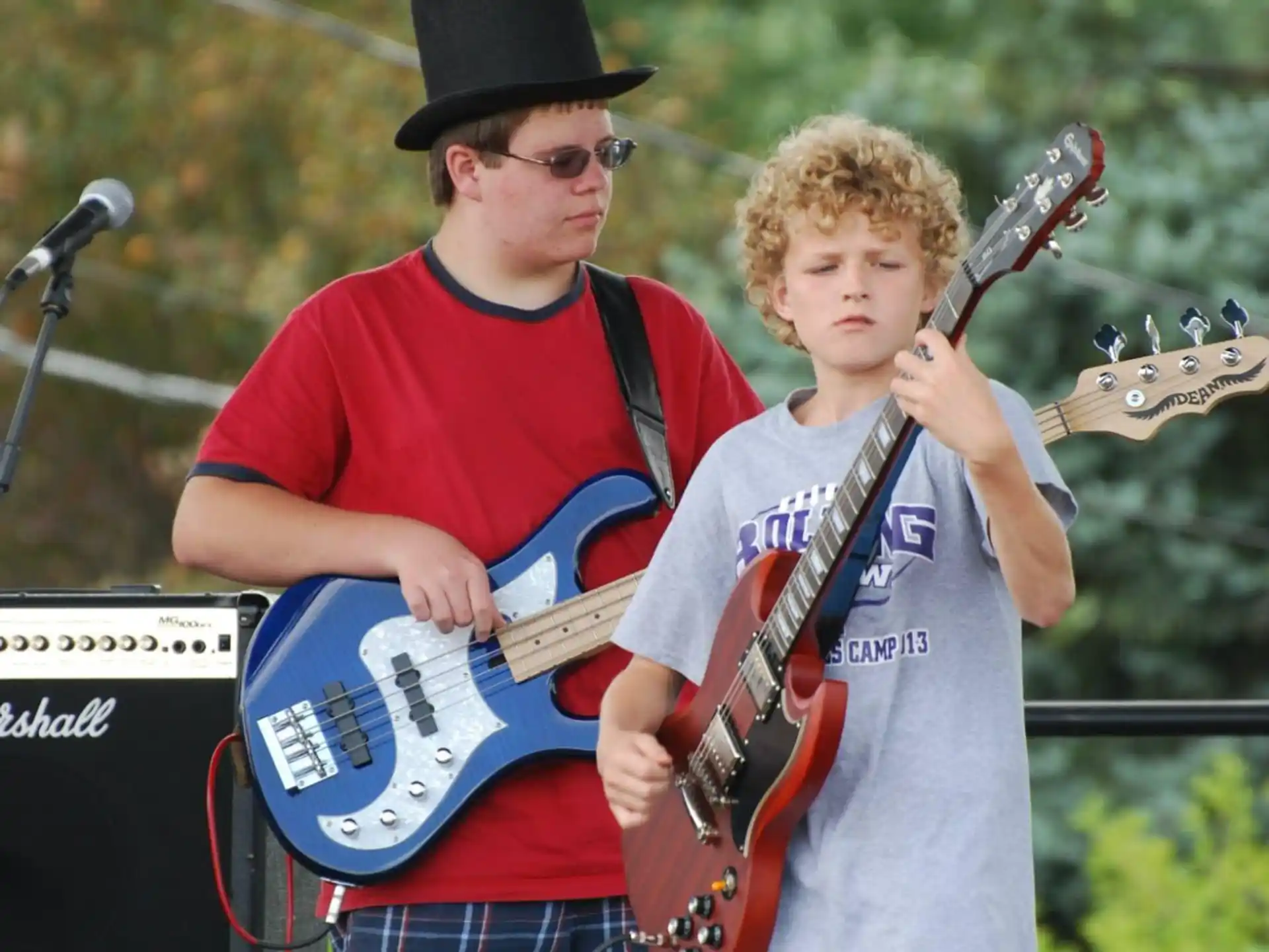 two boys holding musical instruments