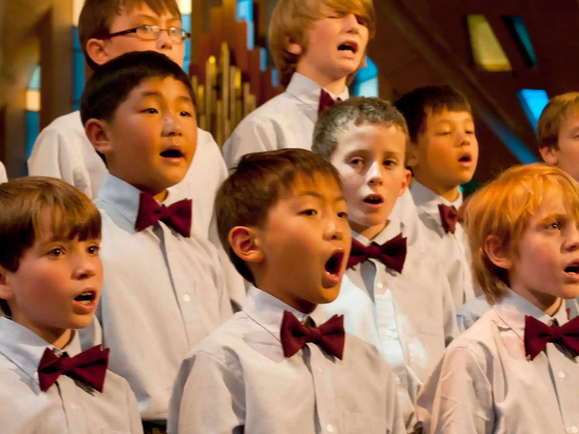 a group of children in white uniforms