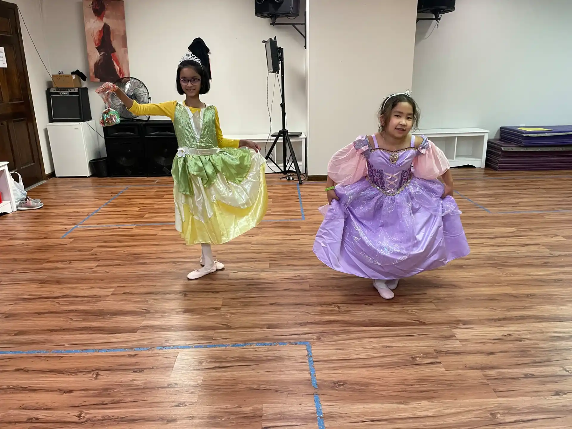 two girls wearing dresses and dancing