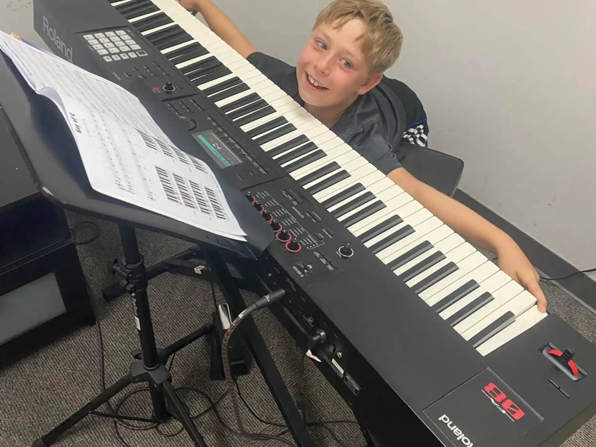 a boy playing a piano