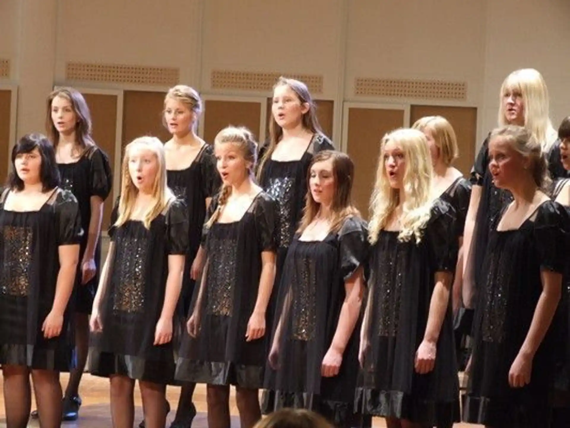 a group of women in black dresses
