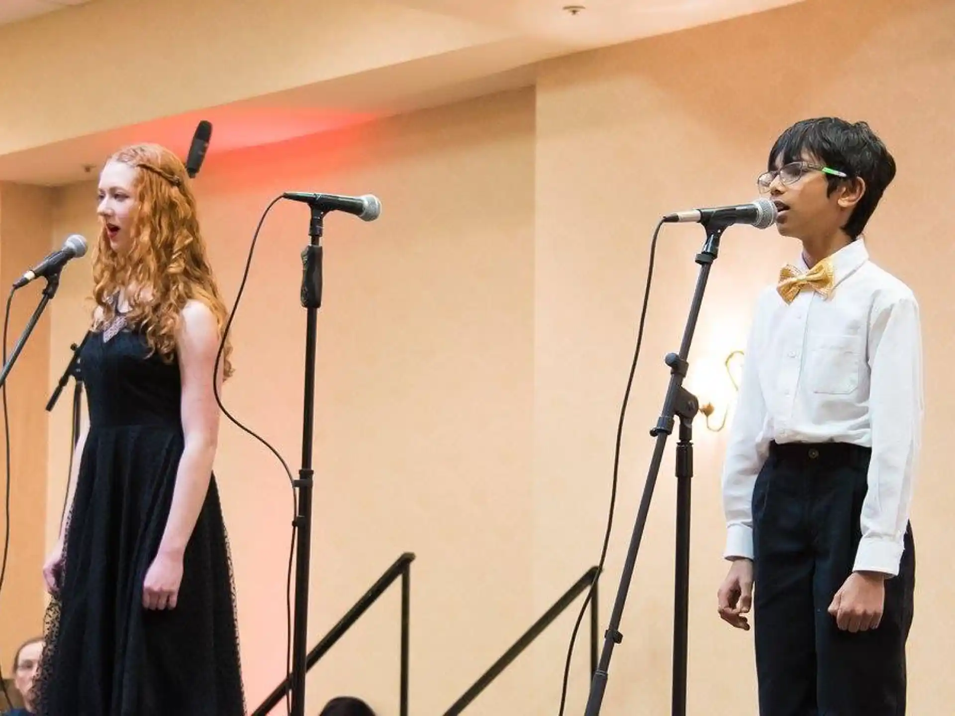 a man and woman singing into microphones