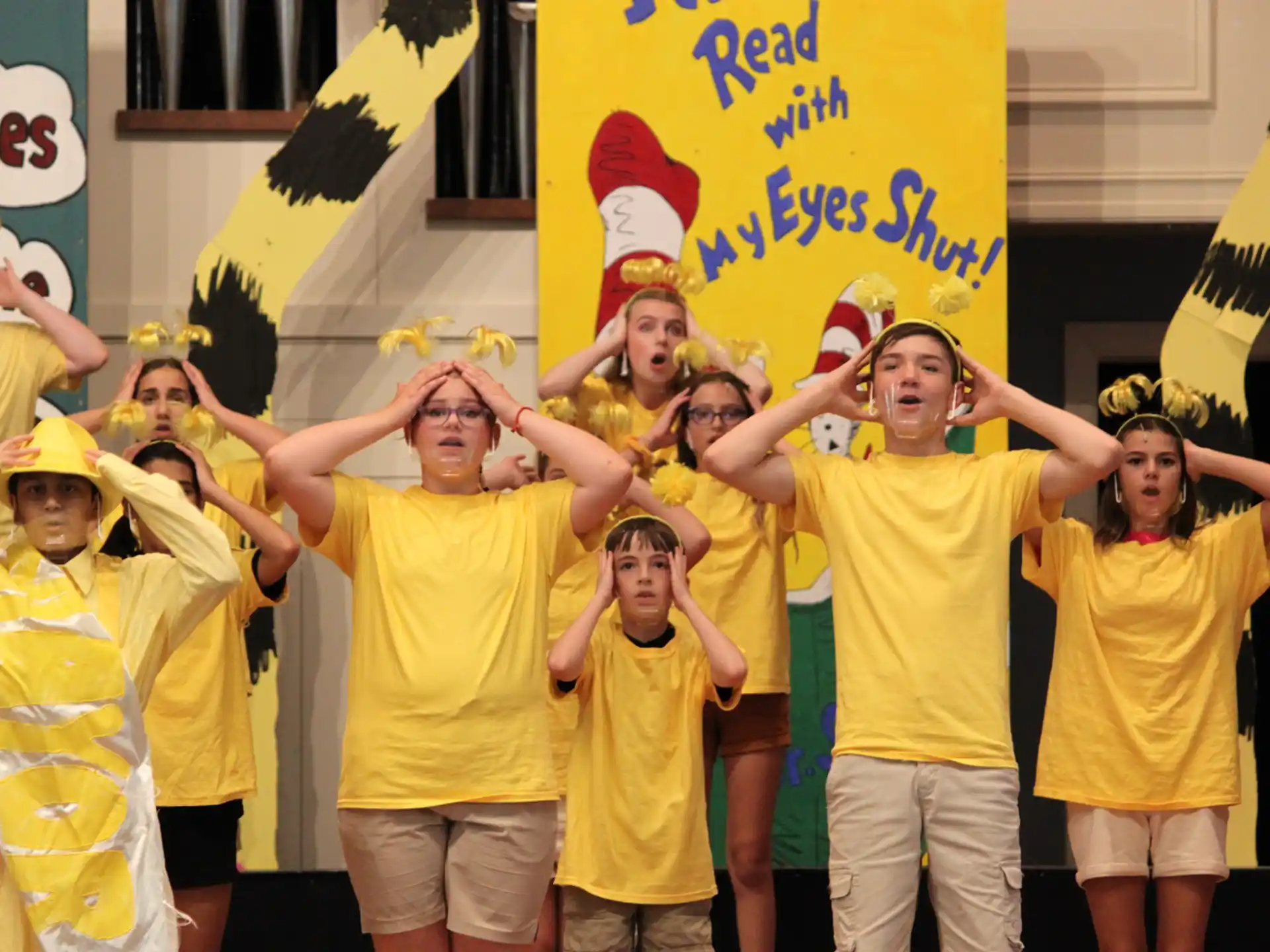 a group of people wearing yellow shirts
