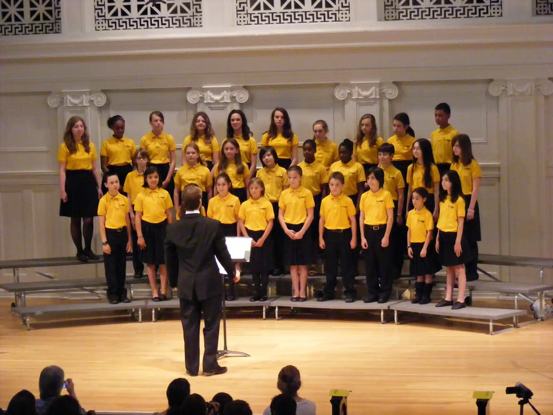 a group of people in yellow shirts