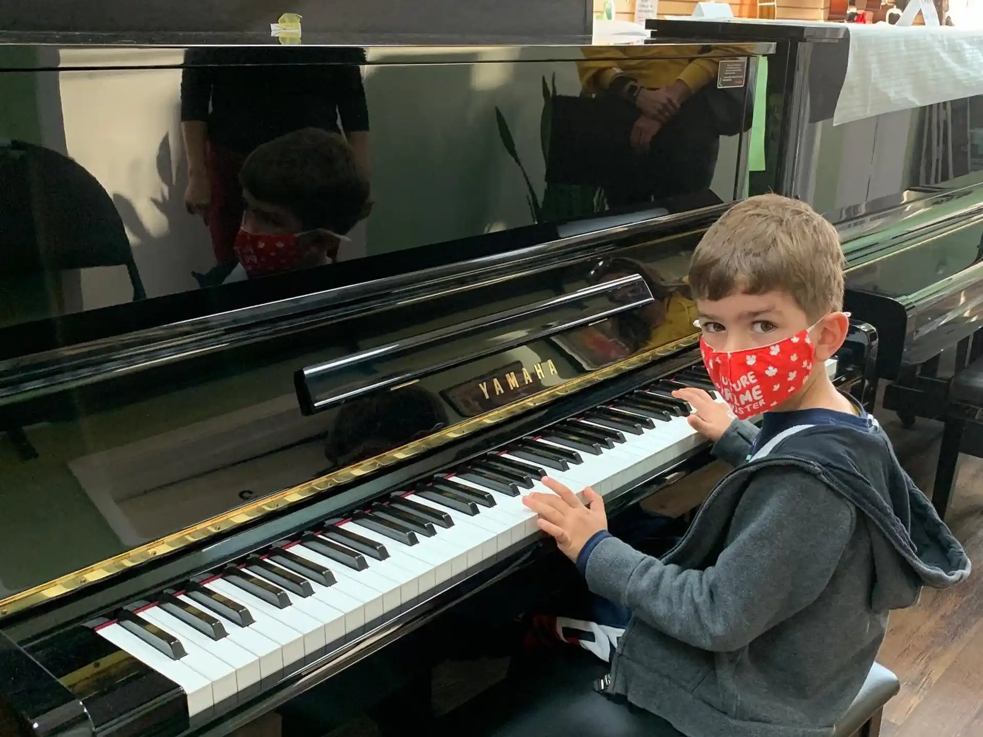 a boy playing a piano