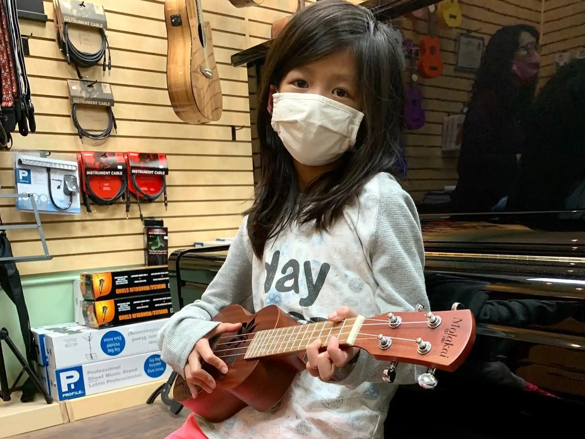 a girl with a mask playing a guitar