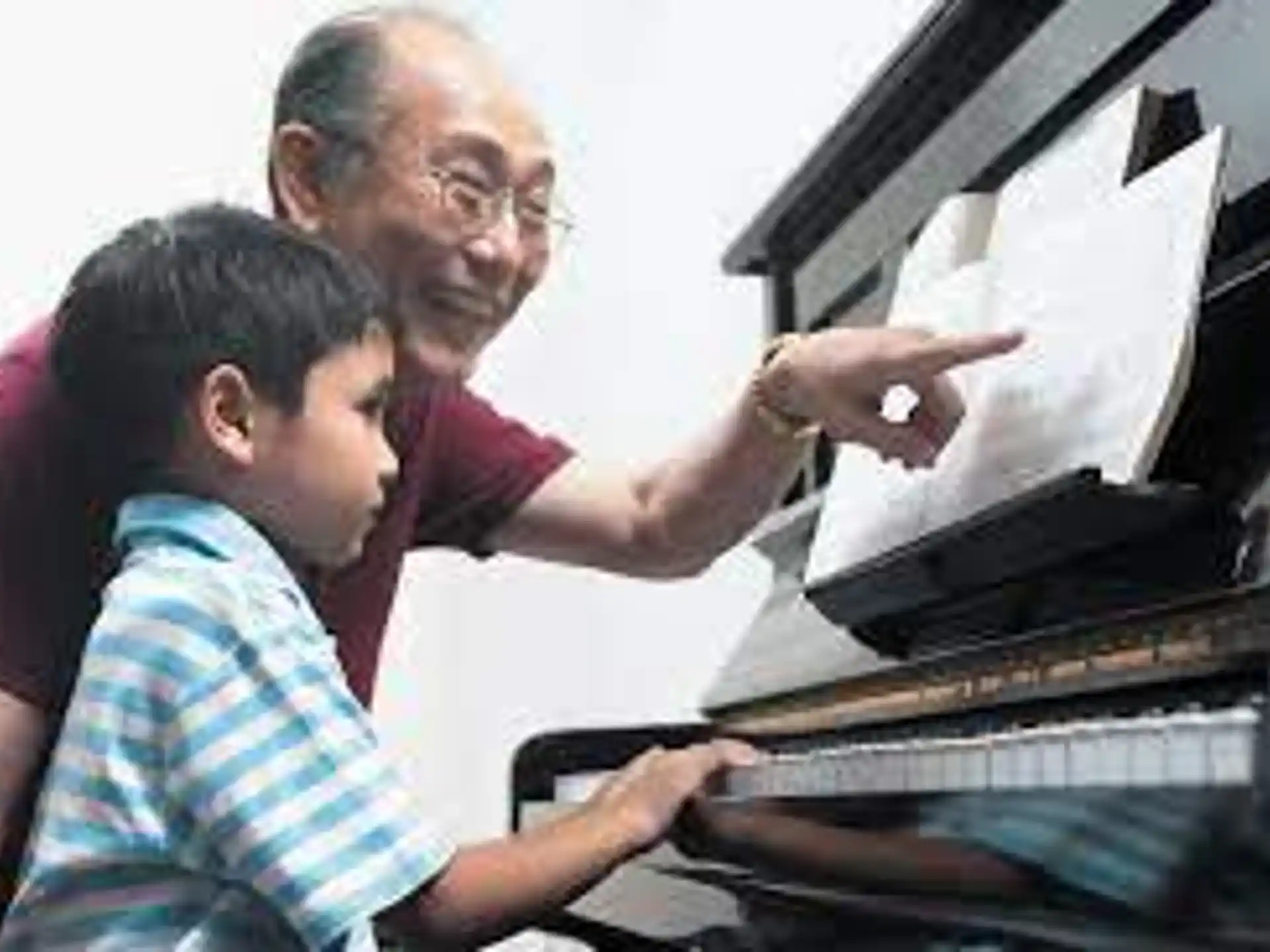 a man and a child looking at a computer screen