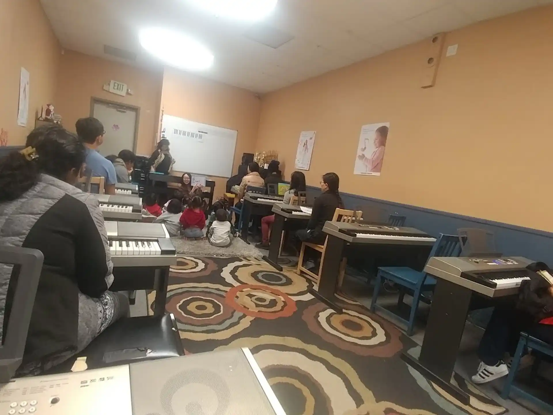 a group of people sitting at desks in a room